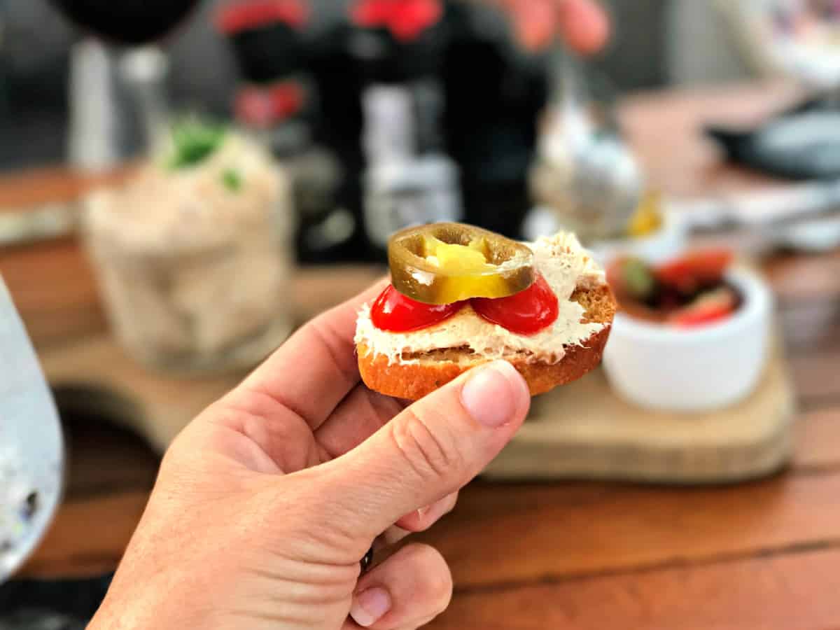 Crostini with smoked tuna dip and jalapenos.
