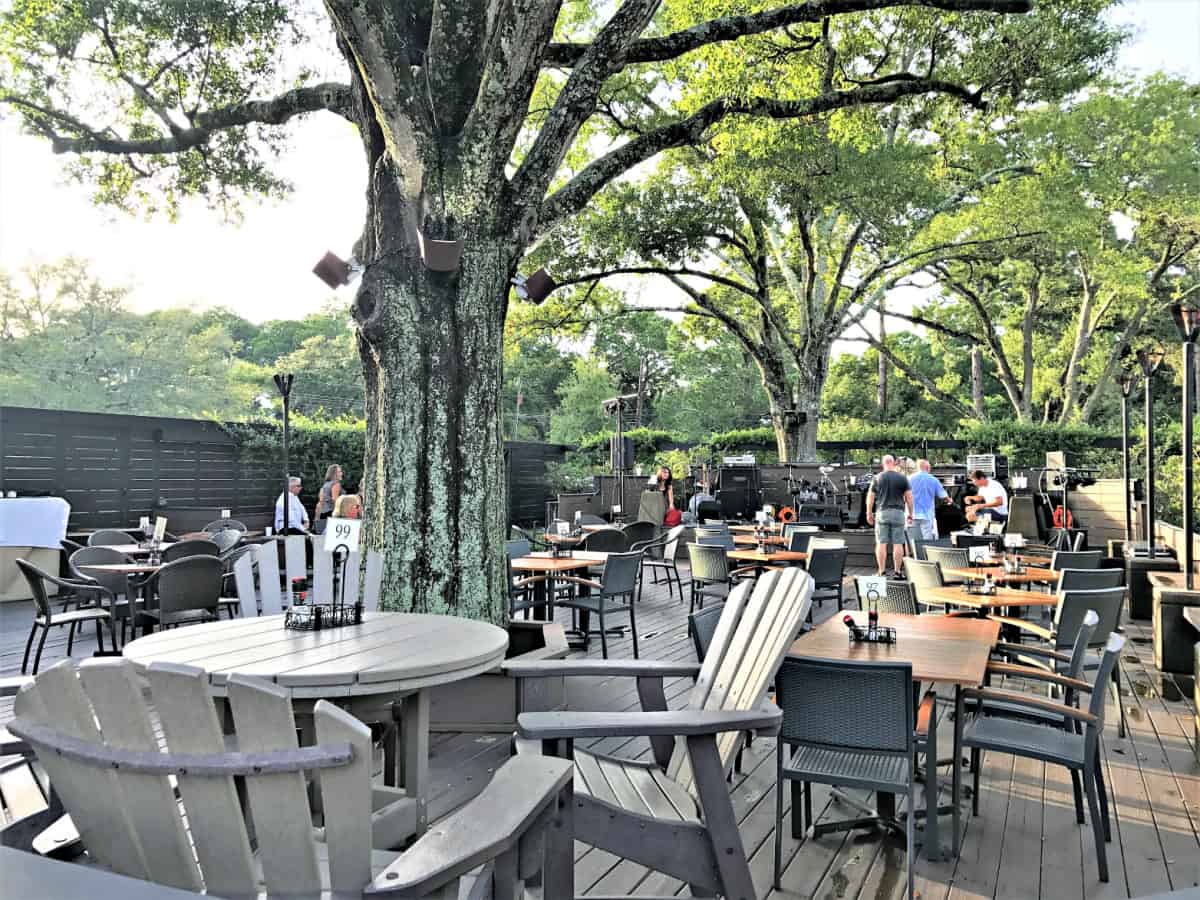 Outdoor patio dining with deck built around trees.