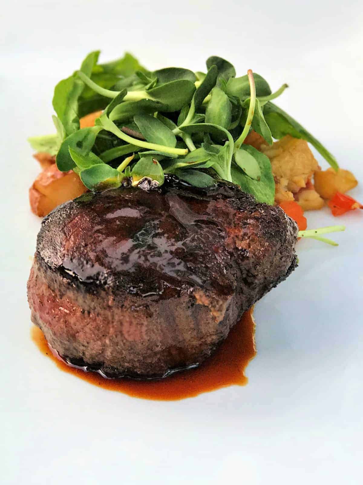 Steak with potatoes and greens.