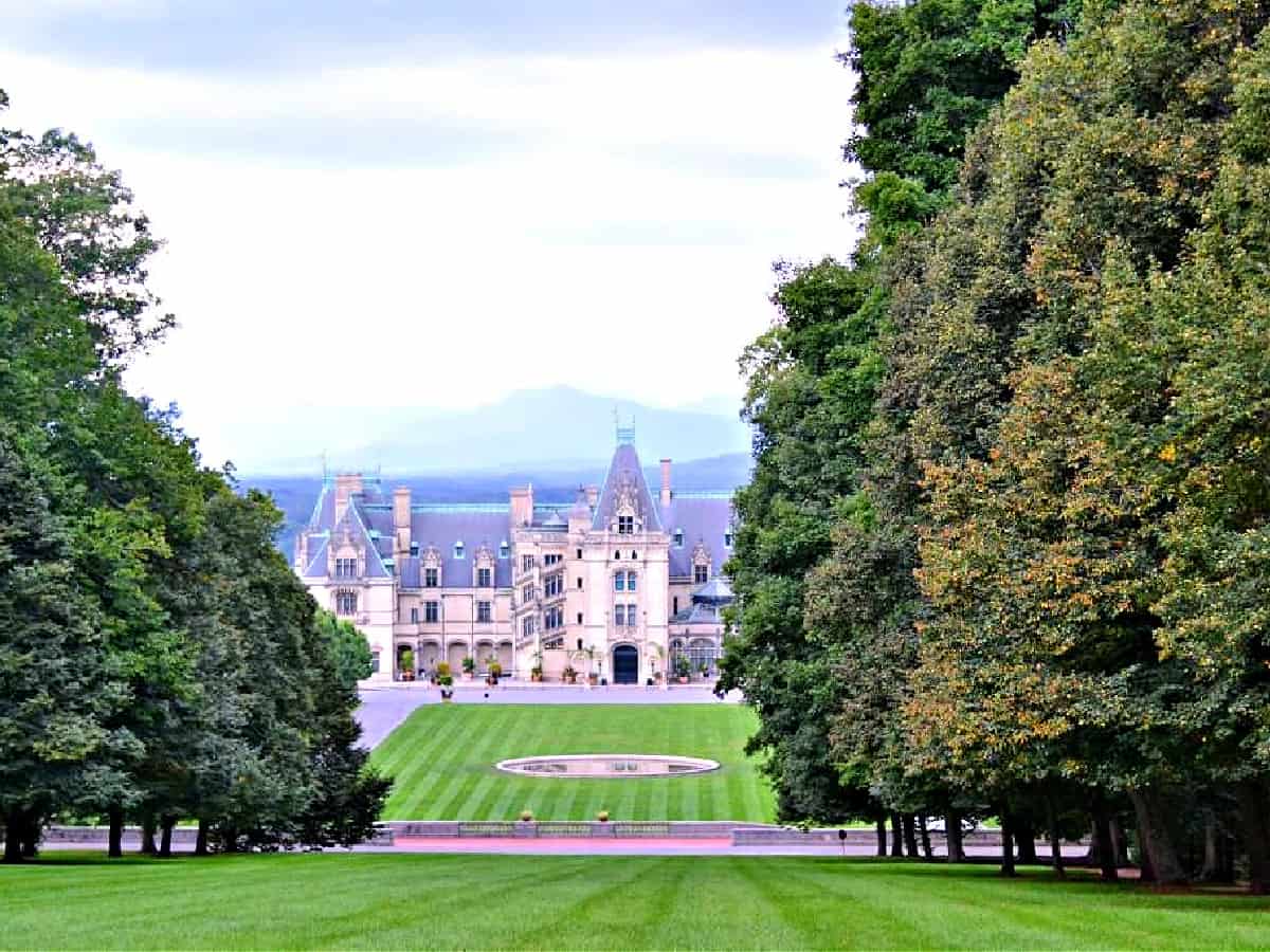 Biltmore Estate - America's Castle Biltmore Estate with rolling green hills in the foreground.