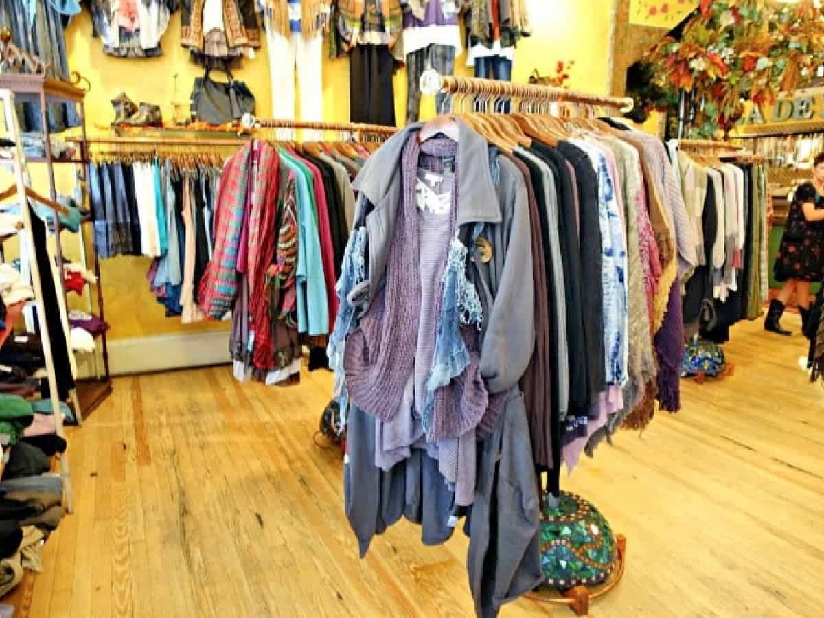 Clothes hanging on a rack for sale.