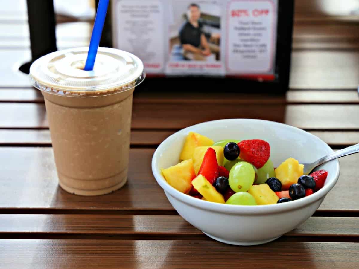 Fruit and smoothie on table.
