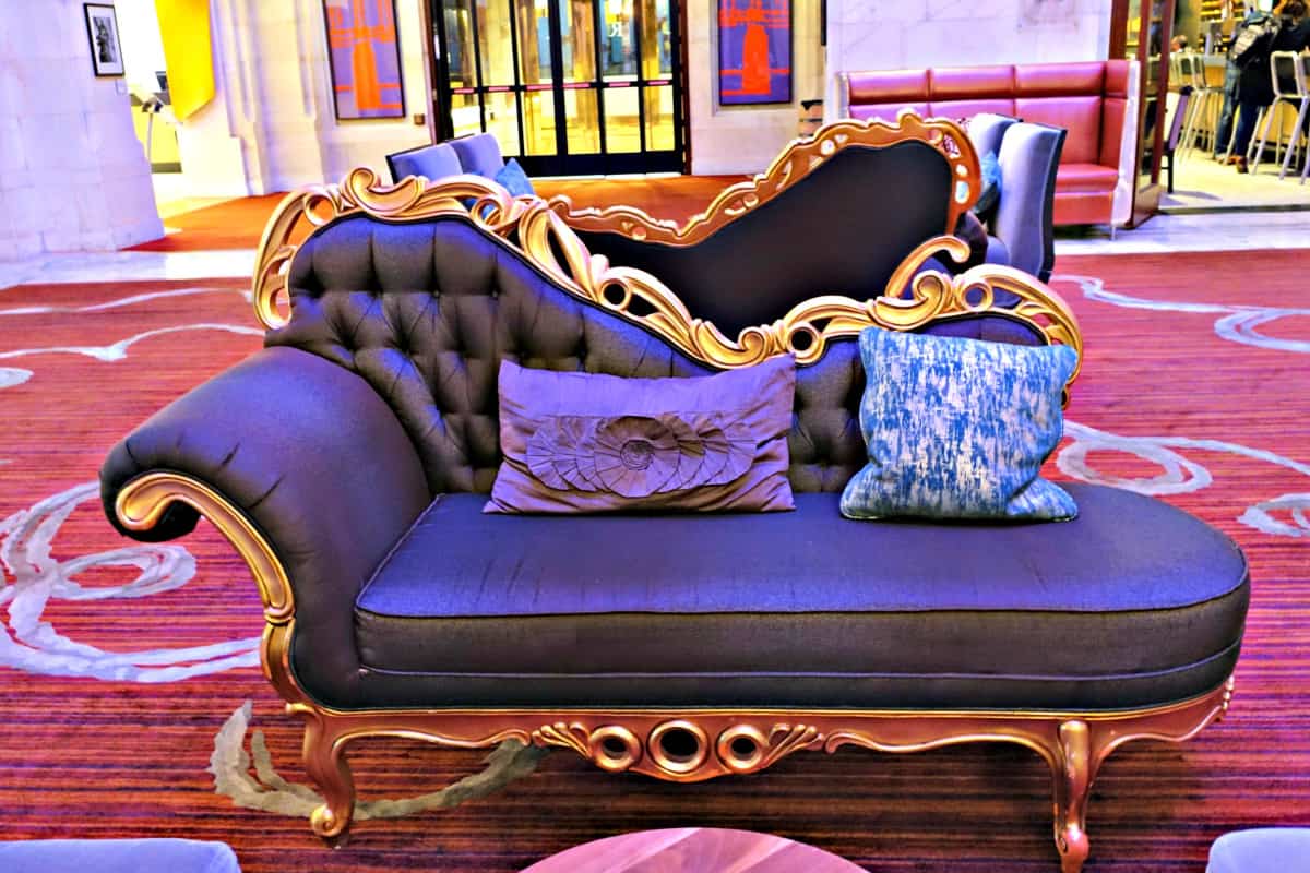Plush purple settee in the hotel’s stylish lobby seating area.