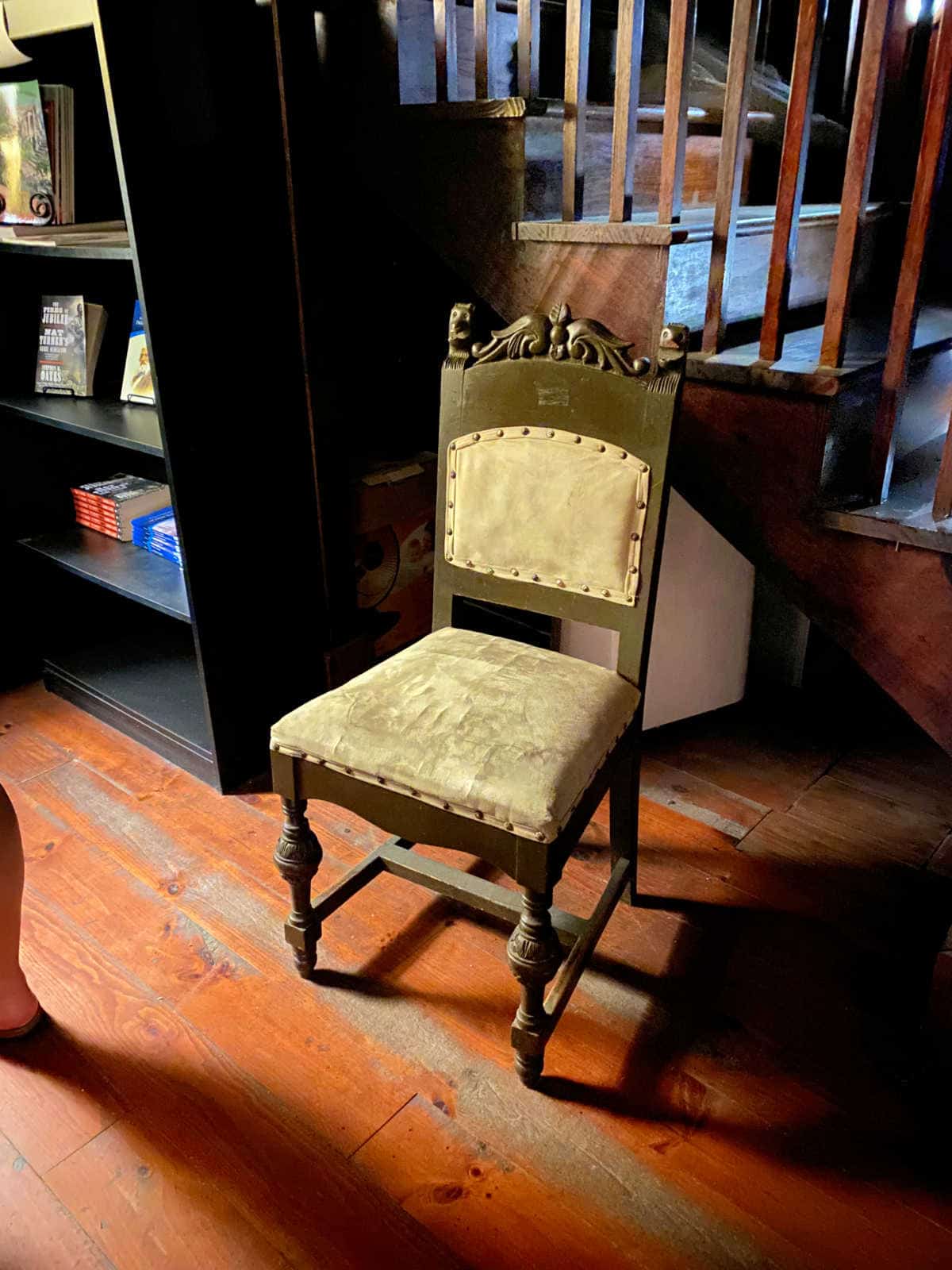 Antique wooden chair in the dimly lit Sorrel-Weed House carriage house.