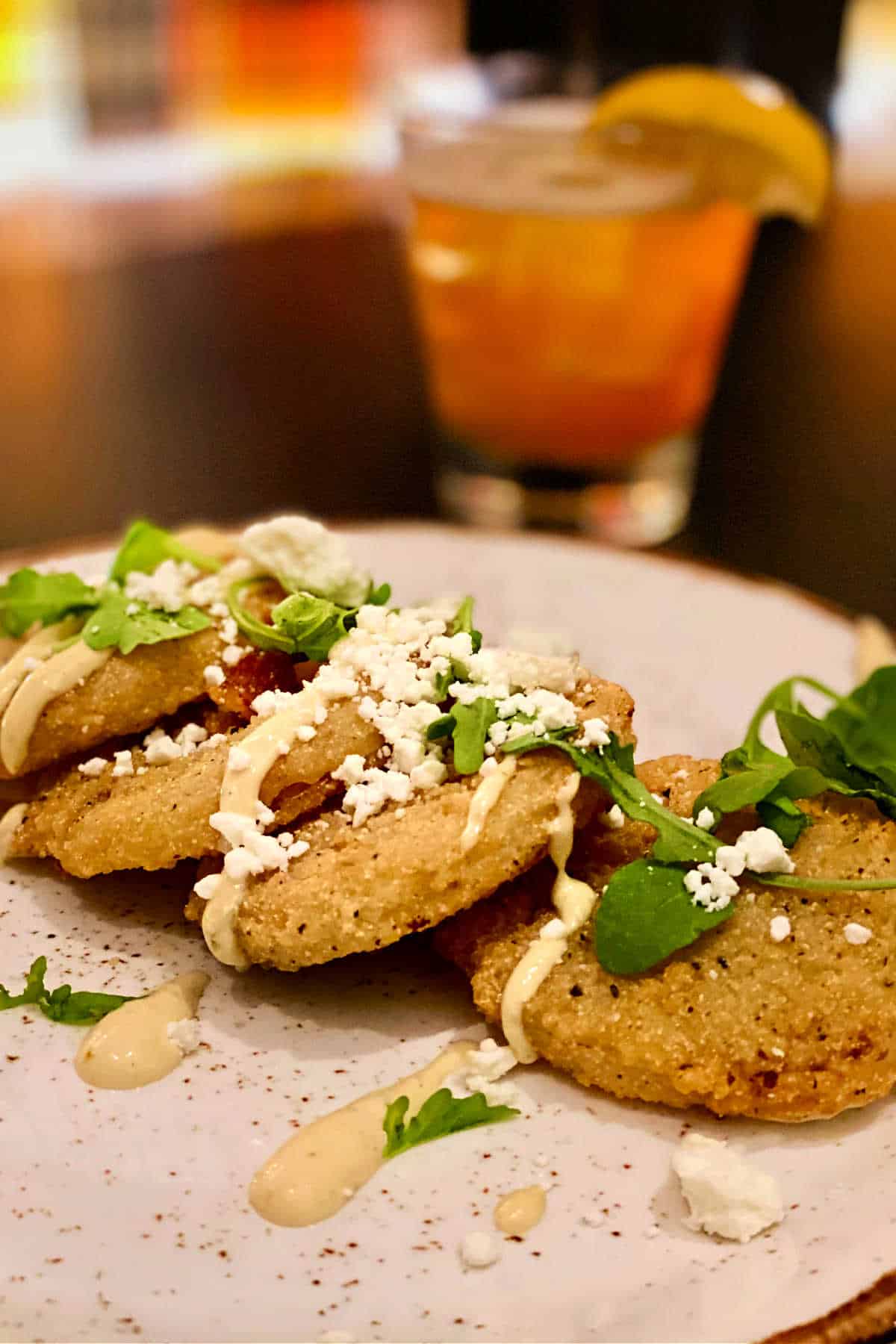 Southern-style fried green tomatoes on a white plate at The DeSoto Savannah.