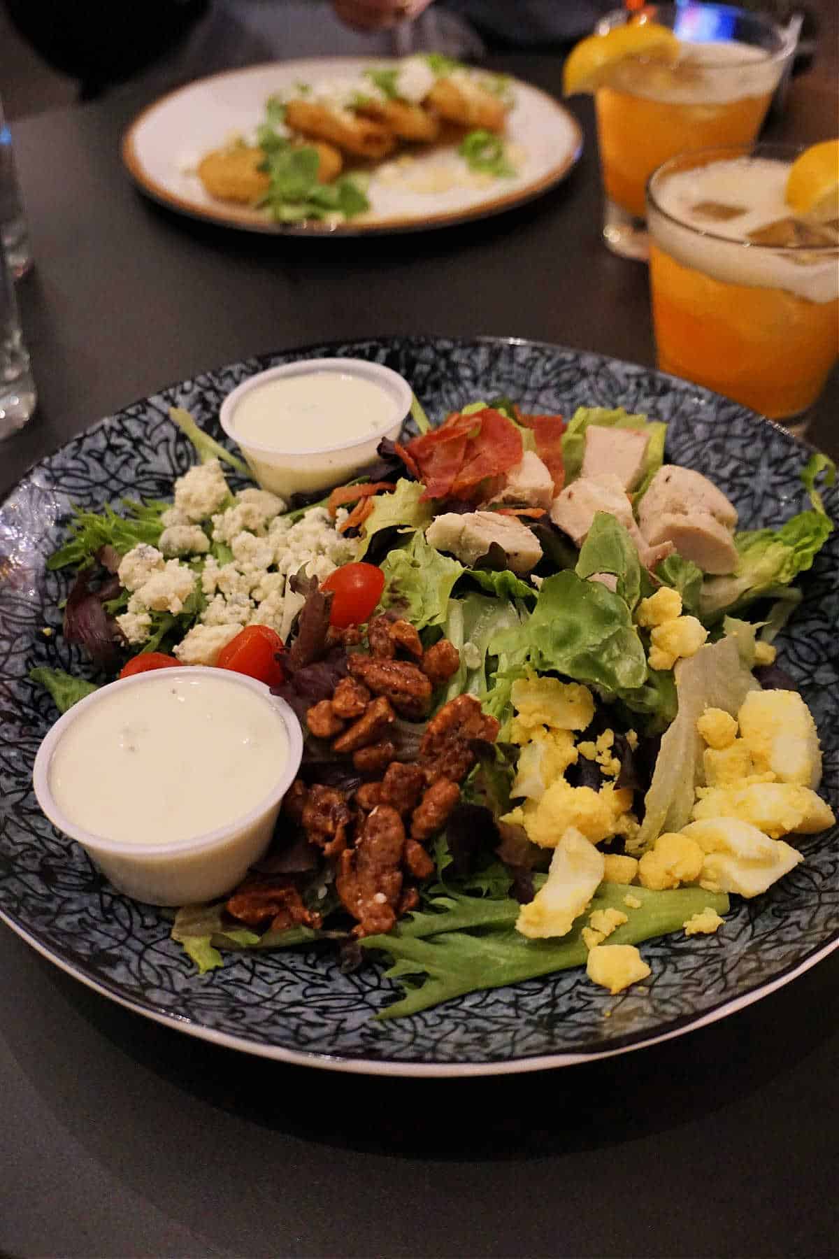 Georgia Cobb Salad topped with fresh greens, bacon, eggs, and avocado at Edgar's Proof and Provisions.