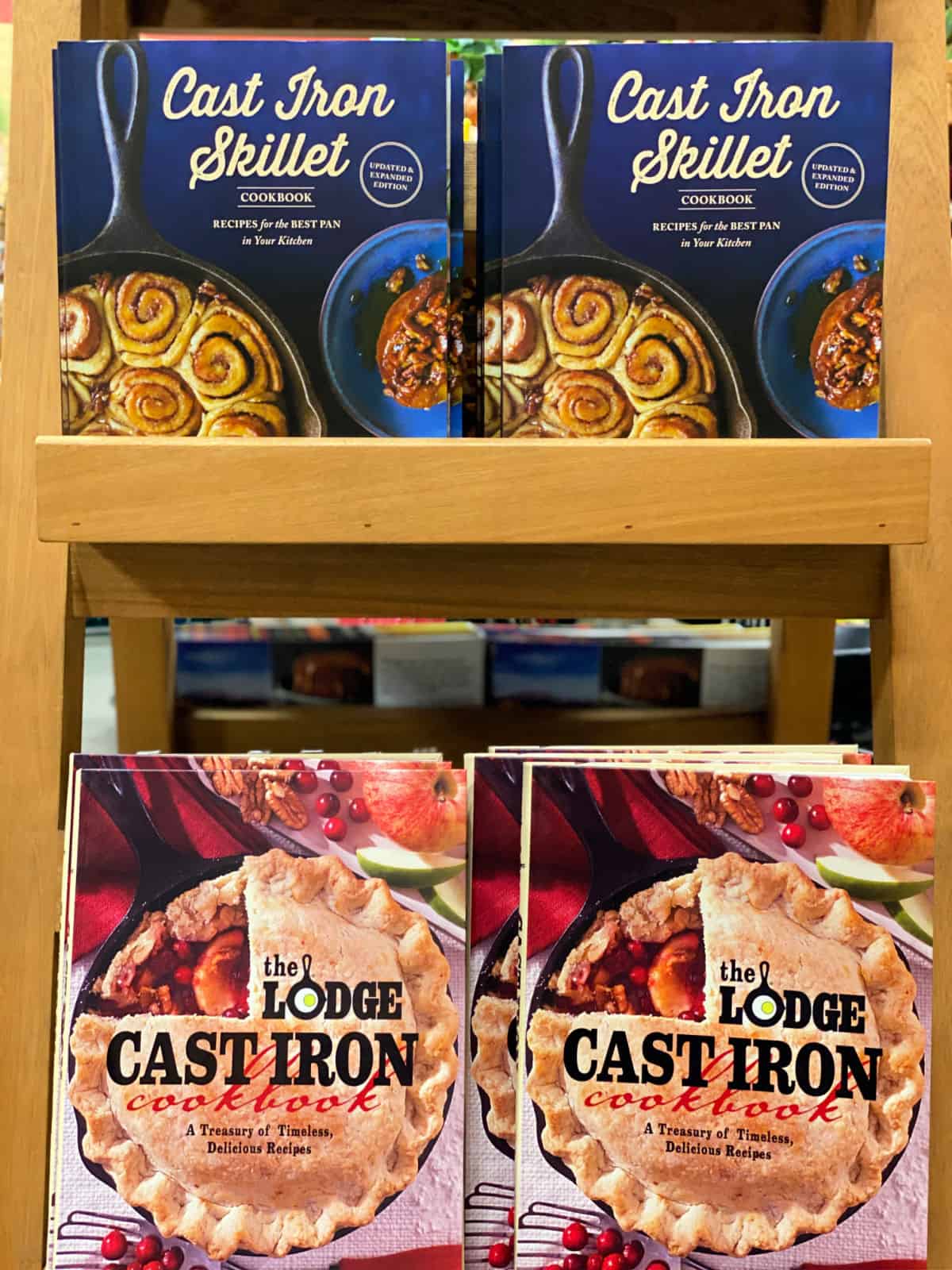 Cast iron cookbooks on a rack.