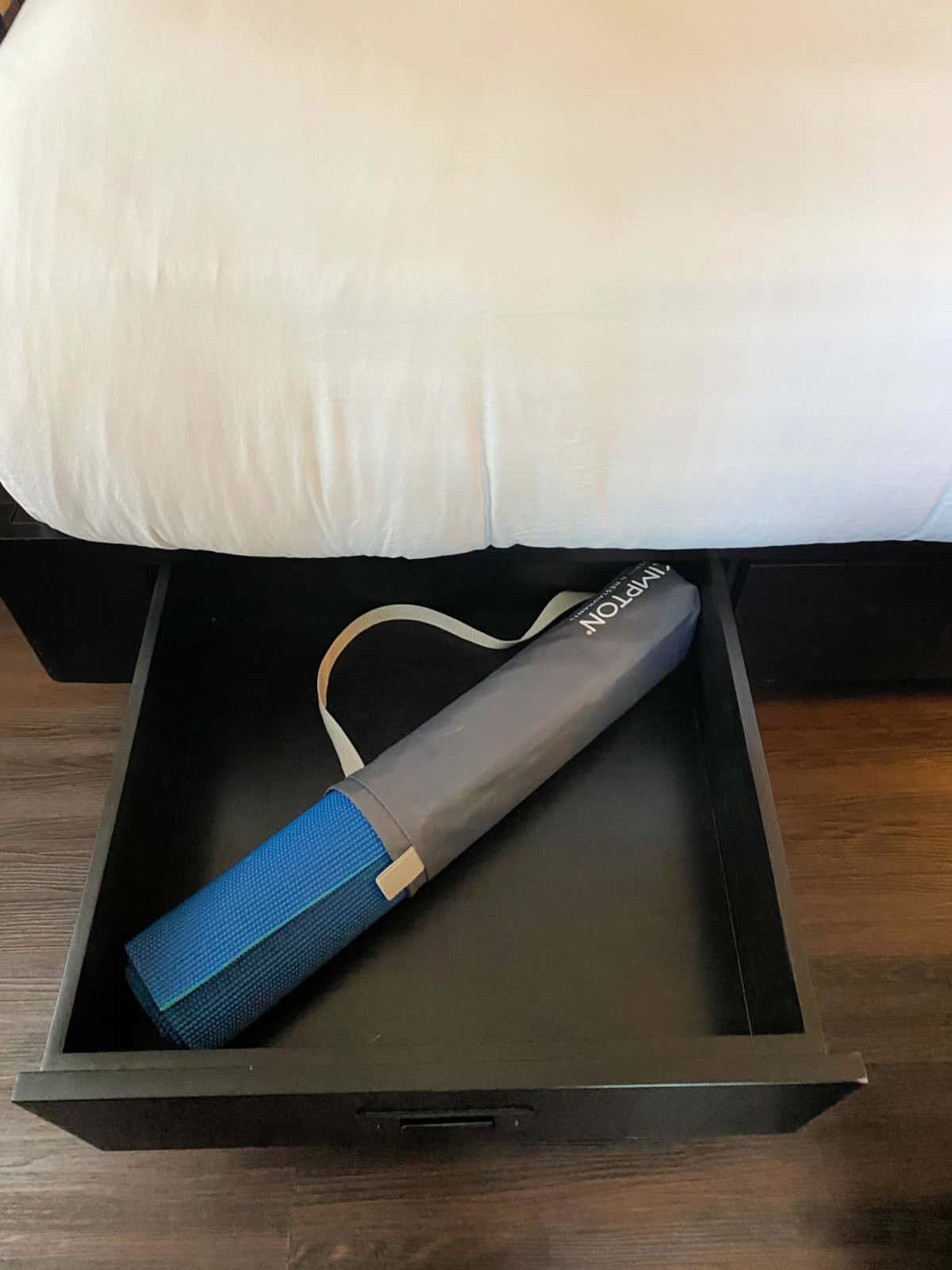 Yoga mat in a drawer underneath a bed.