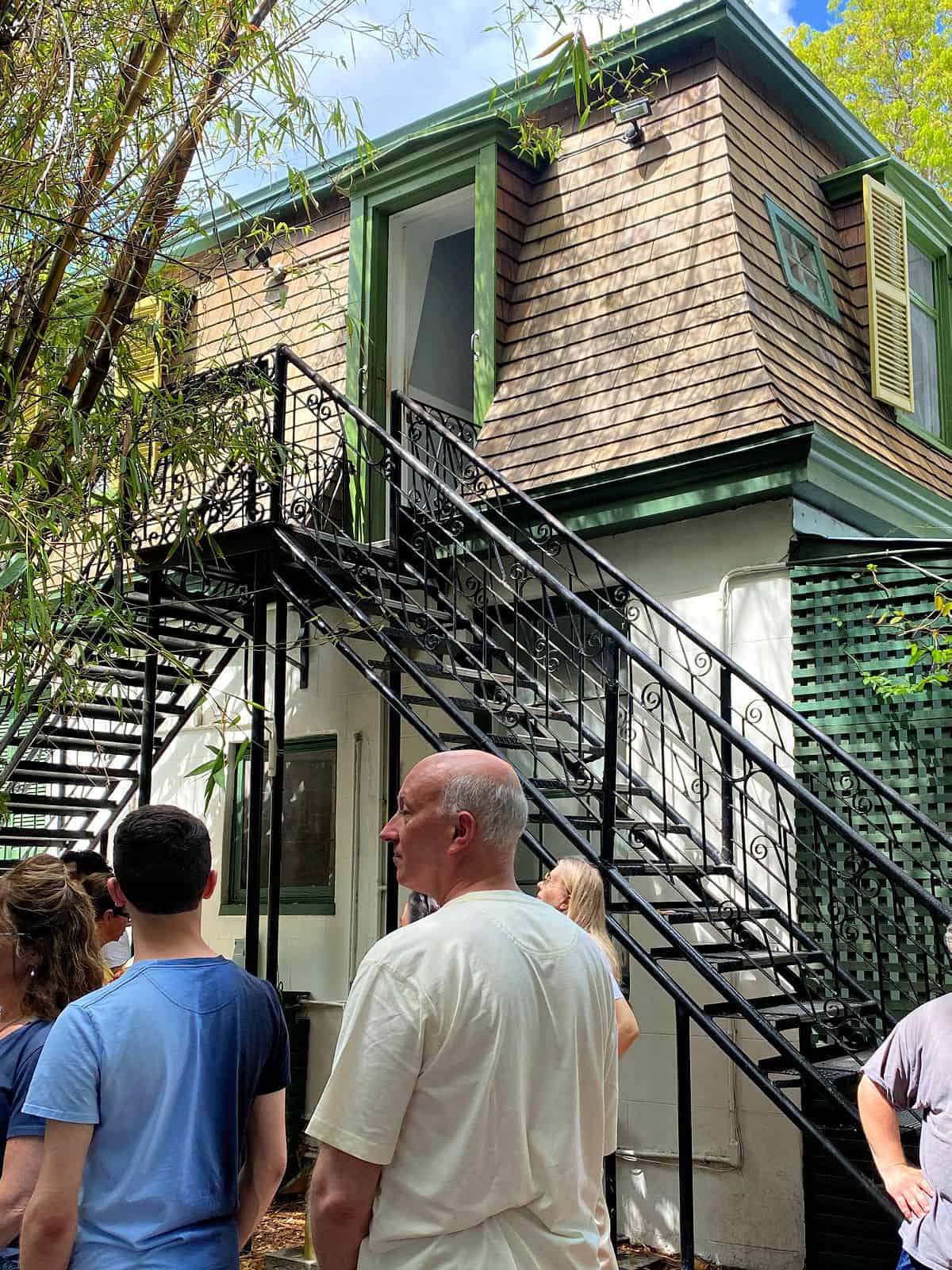 A small two-story building with iron stairs.