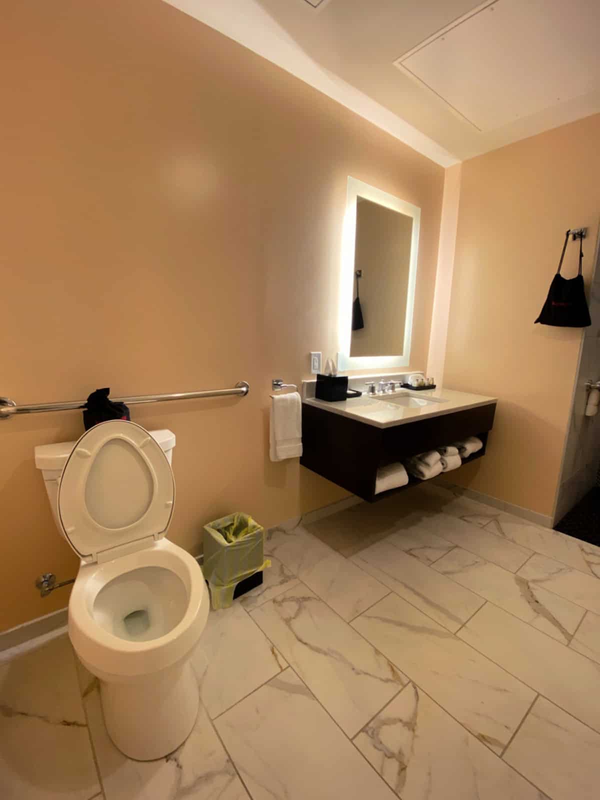 Handicapped-accessible bathroom with a toilet and large vanity.