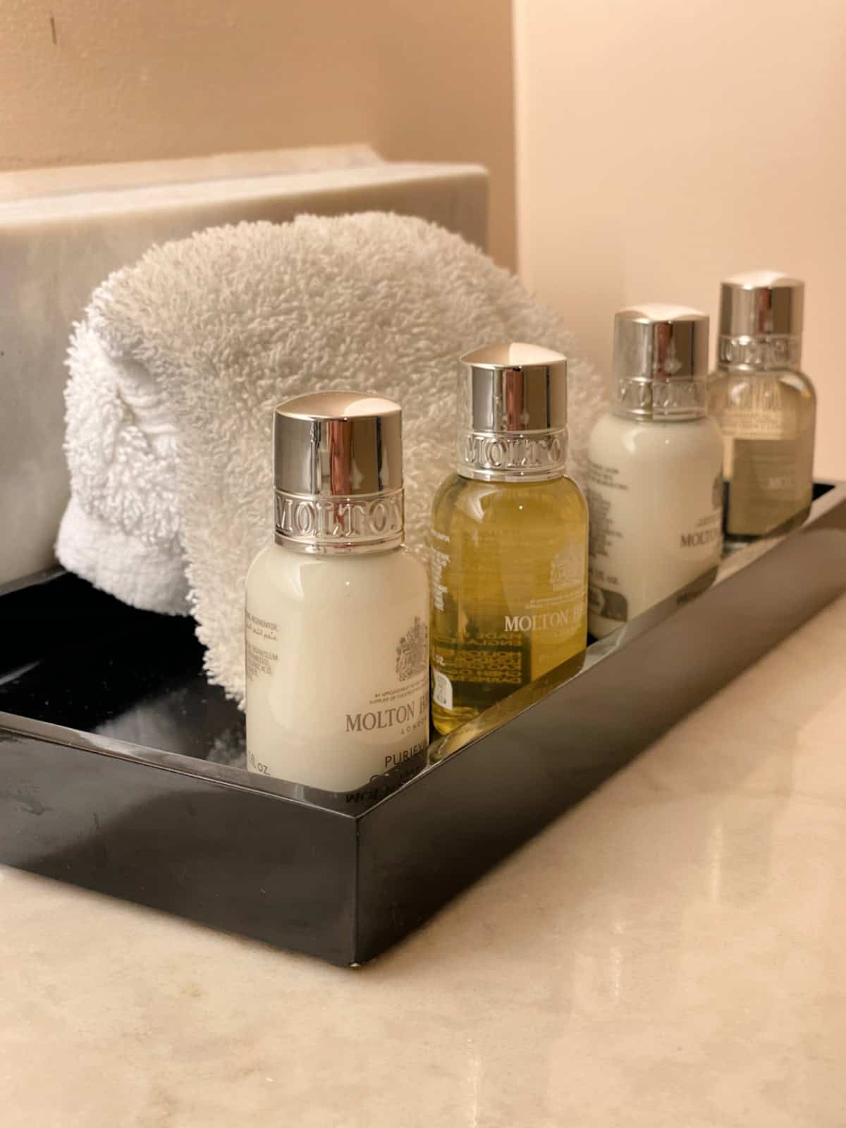 Row of toiletries on a bathroom counter.