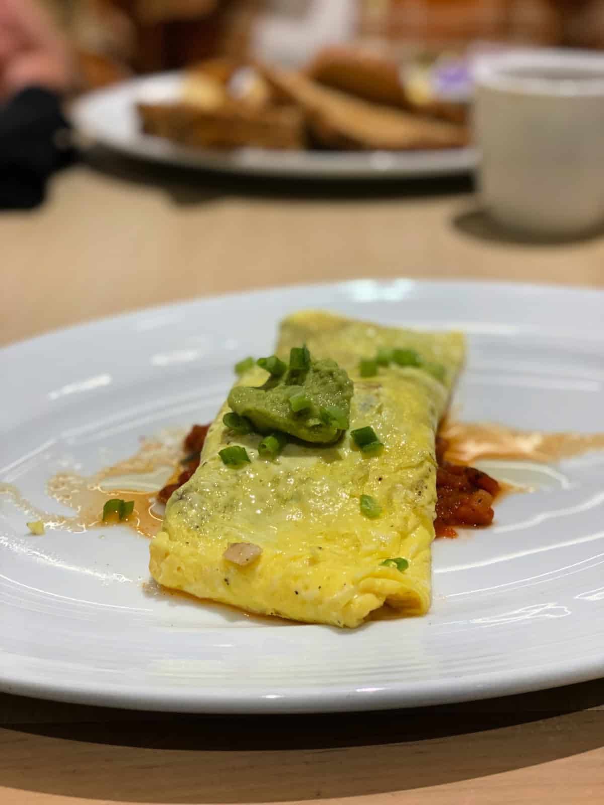 Omelette topped with guacamole.