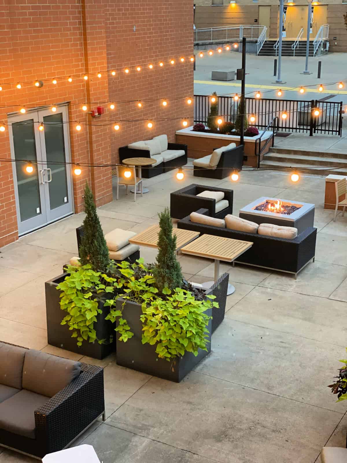 Outdoor patio with seating area and firepit.