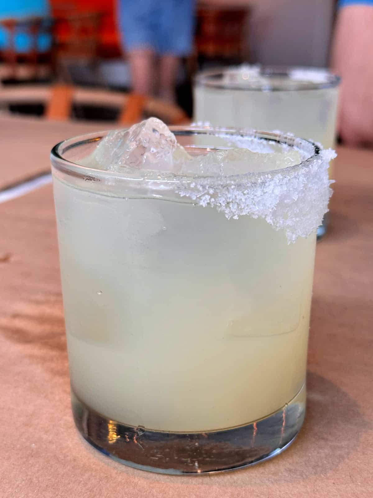 Margarita in a small glass rimmed with salt.