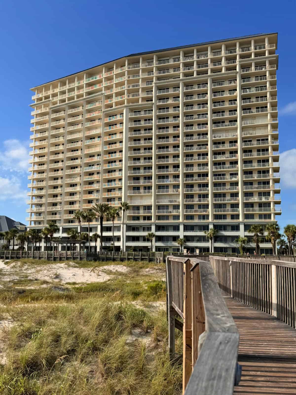 The back of a condominium tower by the beach.