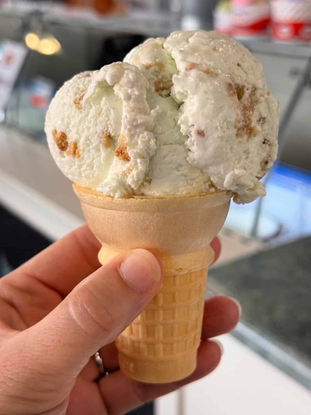 Scoop of Key Lime ice cream in a simple ice cream cone.