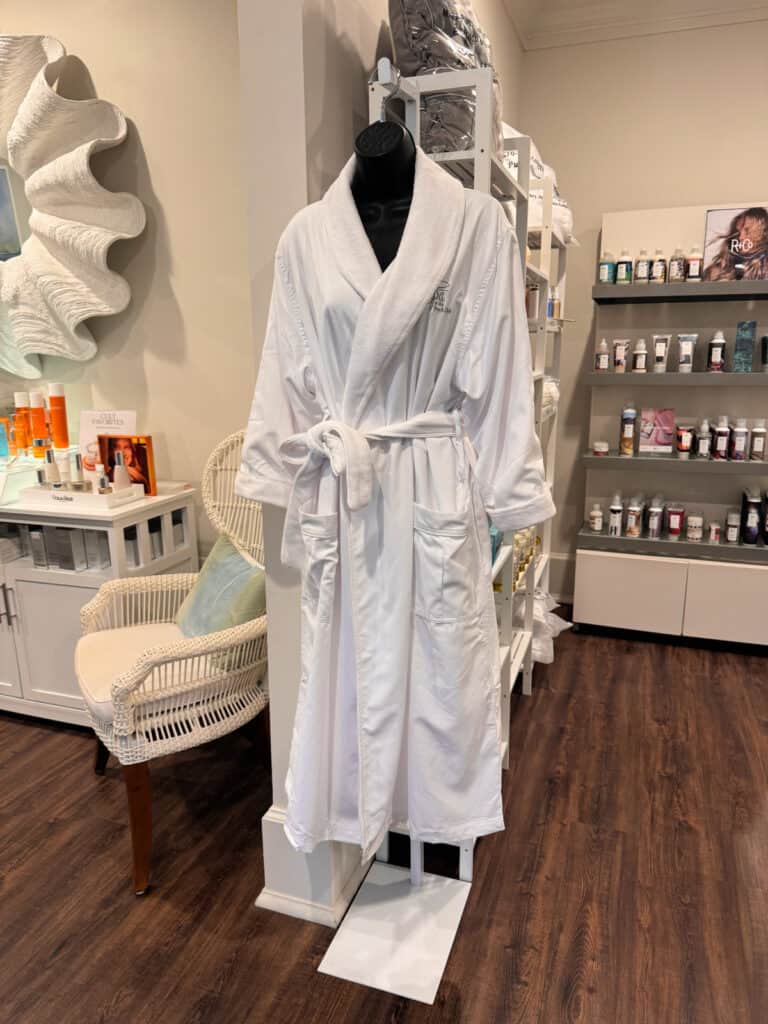 A white robe hanging in a spa.