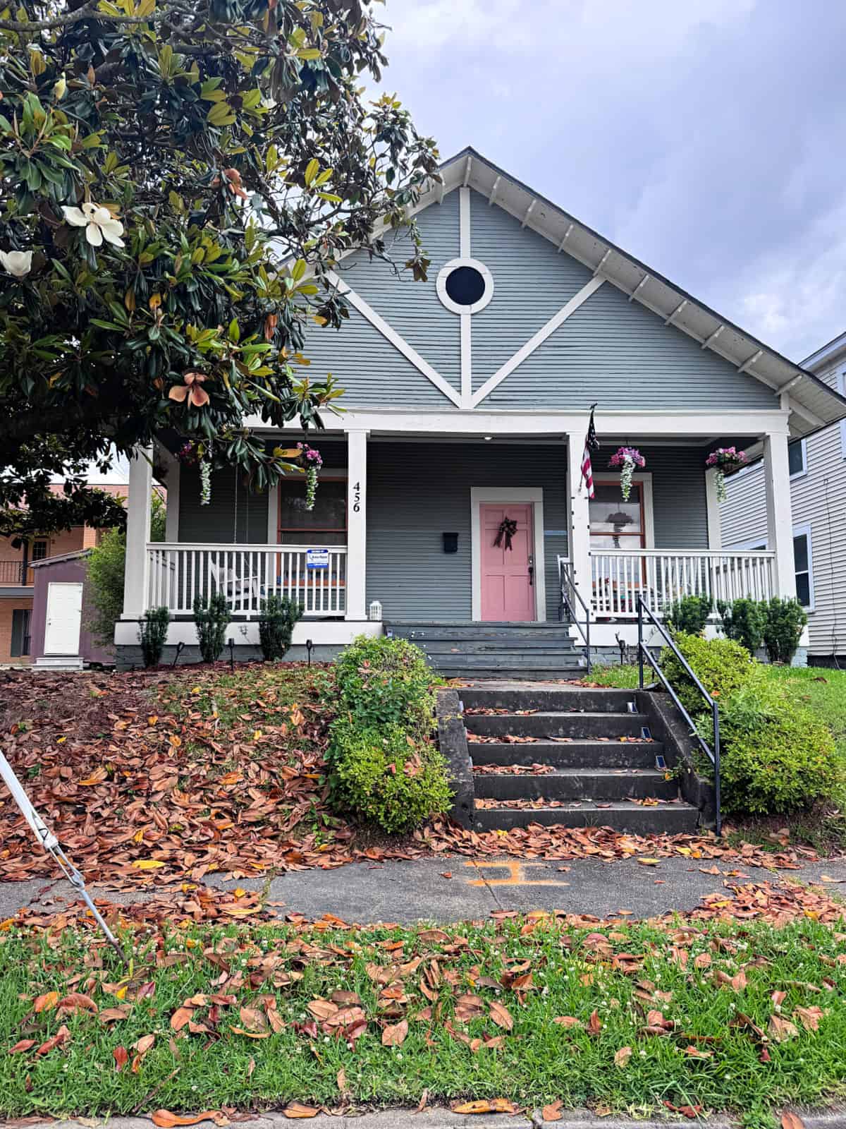 Gray house with a pink door.