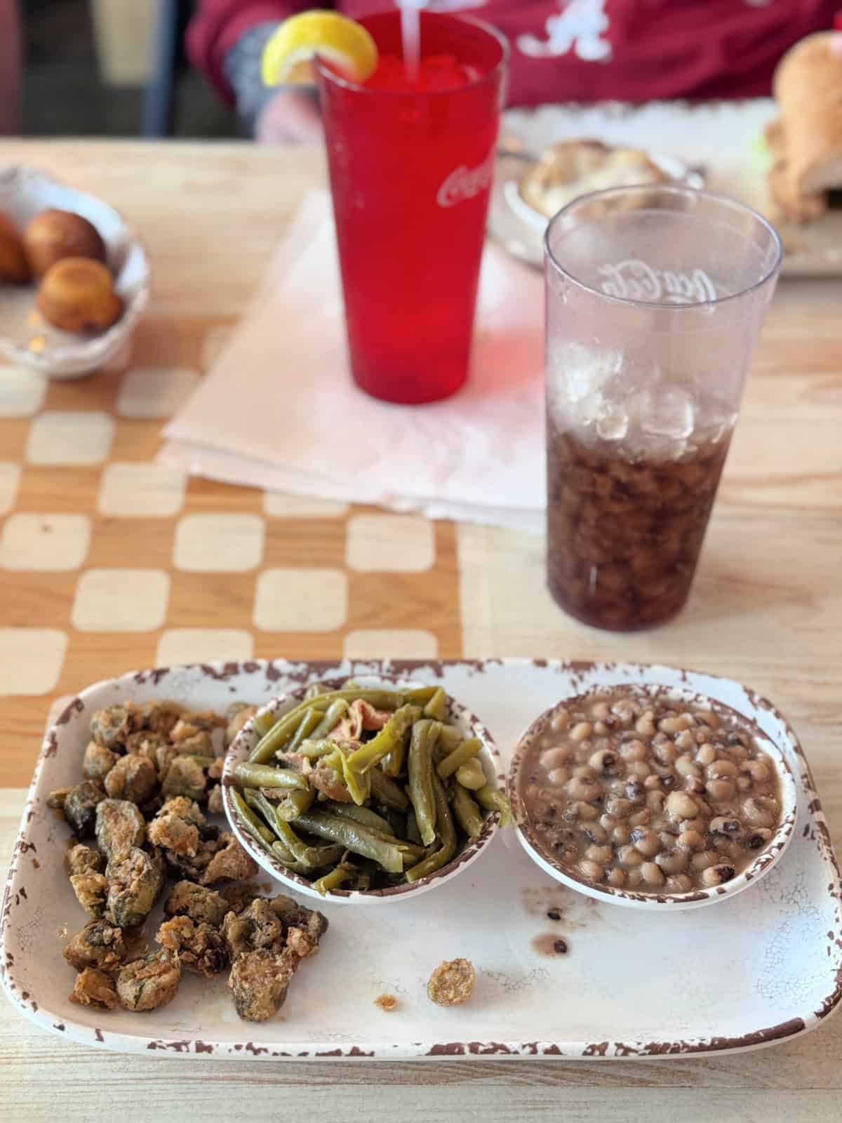 Plate with okra, green beans, and black eyed peas and a glass of diet Coke.