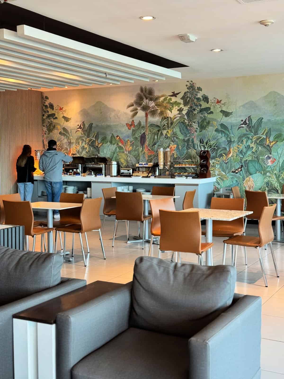 People getting food at a small food buffet.