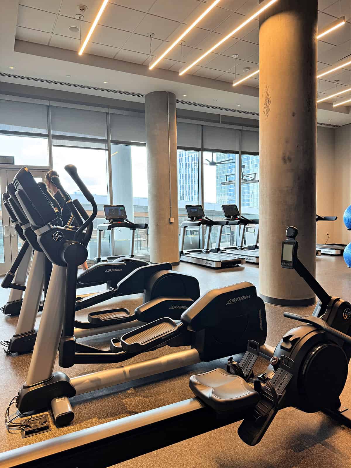 Treadmills and elliptical machines in a hotel gym.