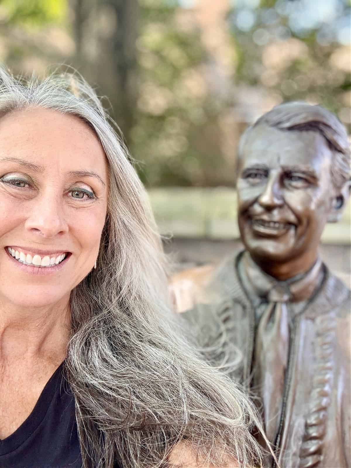 Lynda posing beside the bronze Fred Rogers bench sculpture in downtown Latrobe.