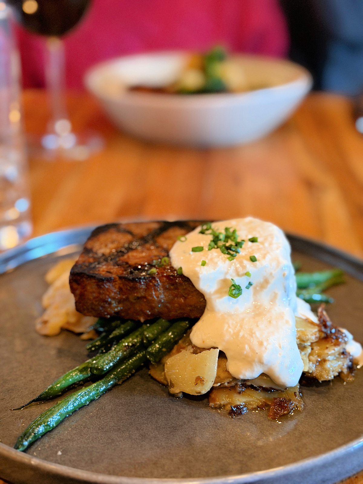 Wood-fired meatloaf with creamy sauce, green beans, and roasted potatoes at Fig & Ash restaurant in Pittsburgh.
