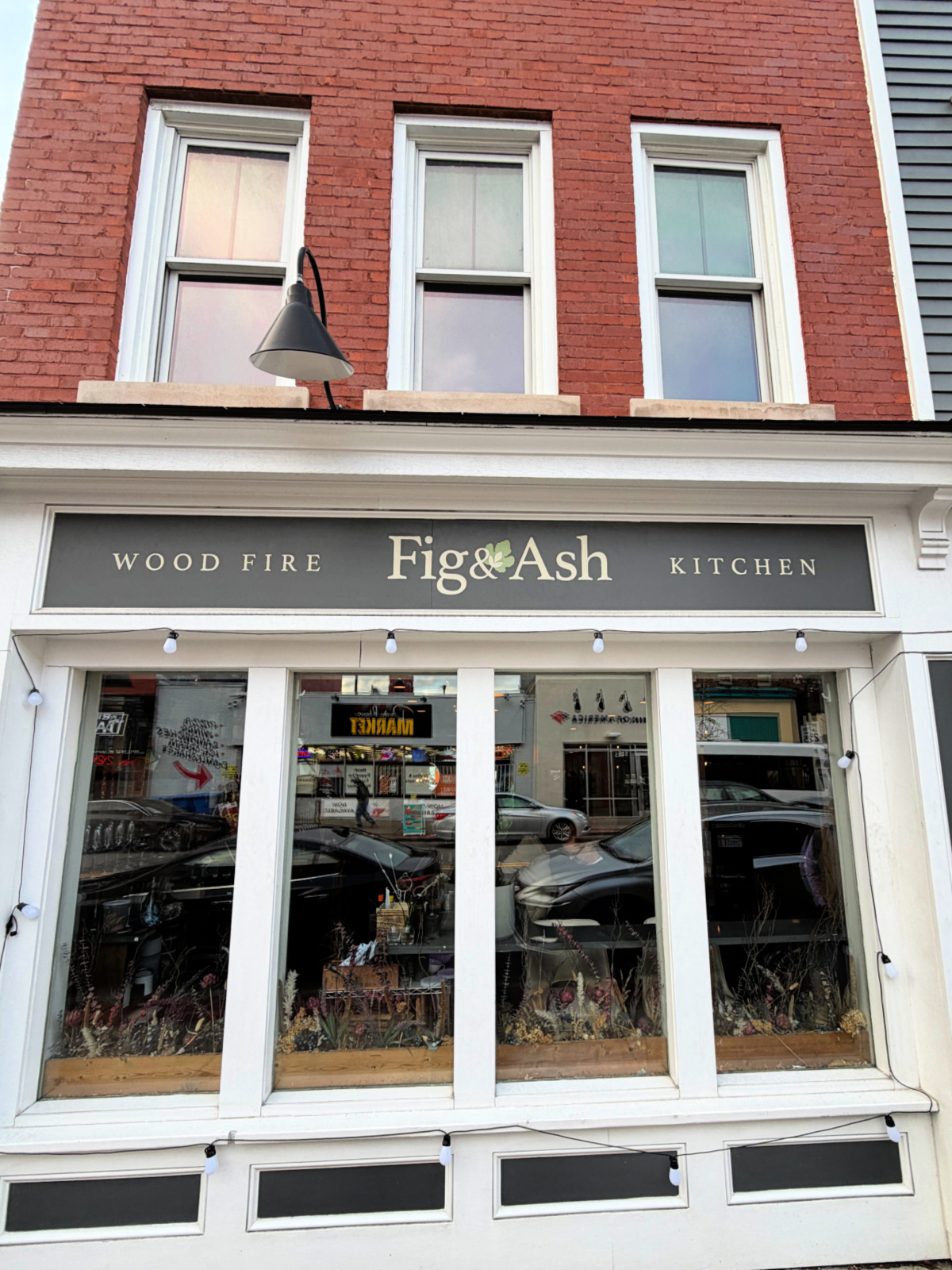 Exterior of Fig & Ash wood-fired kitchen restaurant on Pittsburgh’s North Side with storefront signage.