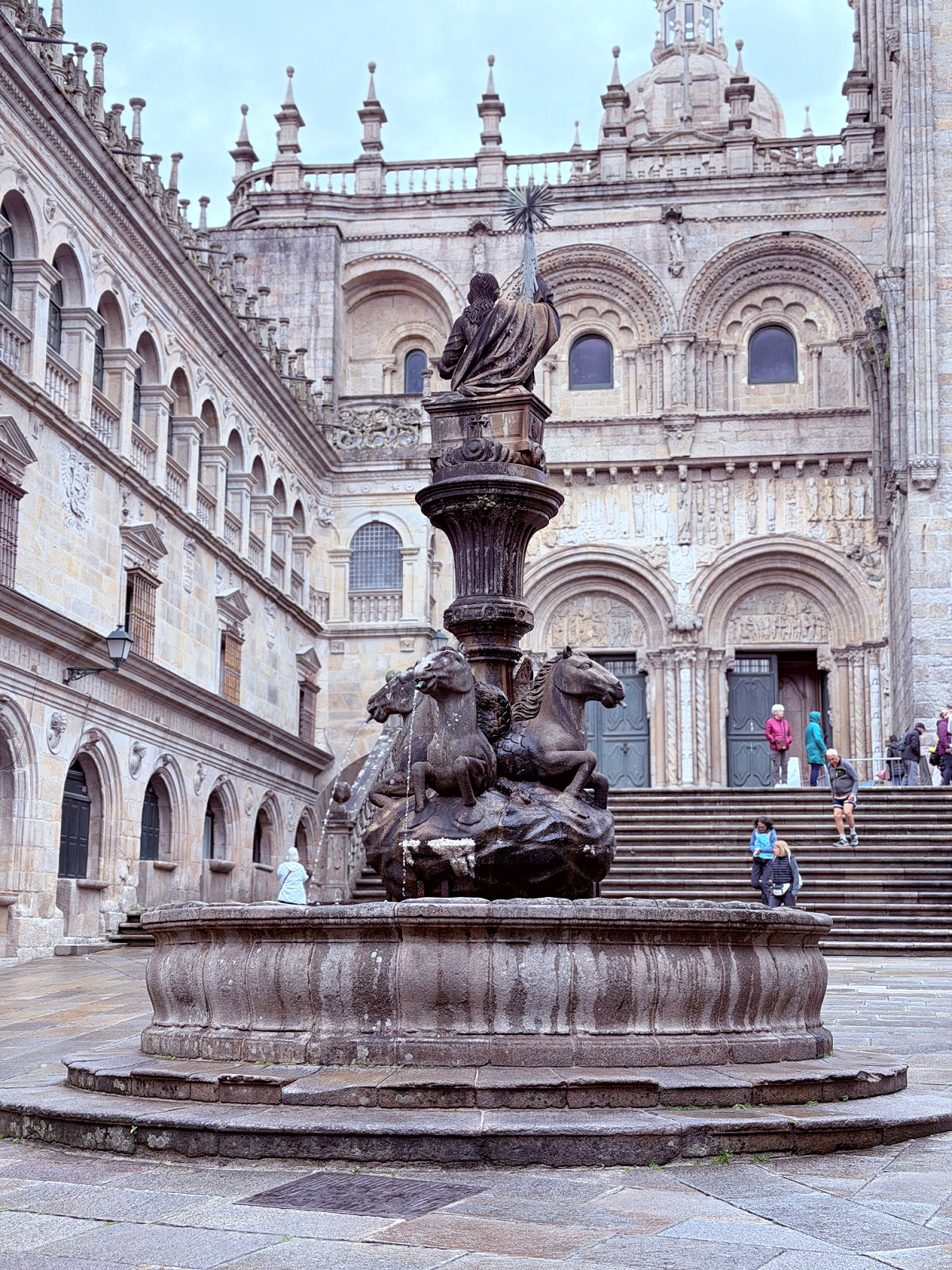 Historic Fountain of Horses and stone architecture in the courtyard beside Santiago de Compostela Cathedral viewed from Hotel Airas Nunes.