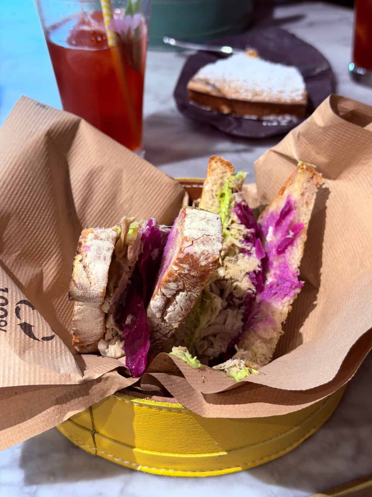 Fresh chicken sandwich on artisan bread served with pickled red cabbage at Costa Vella restaurant in Santiago de Compostela.