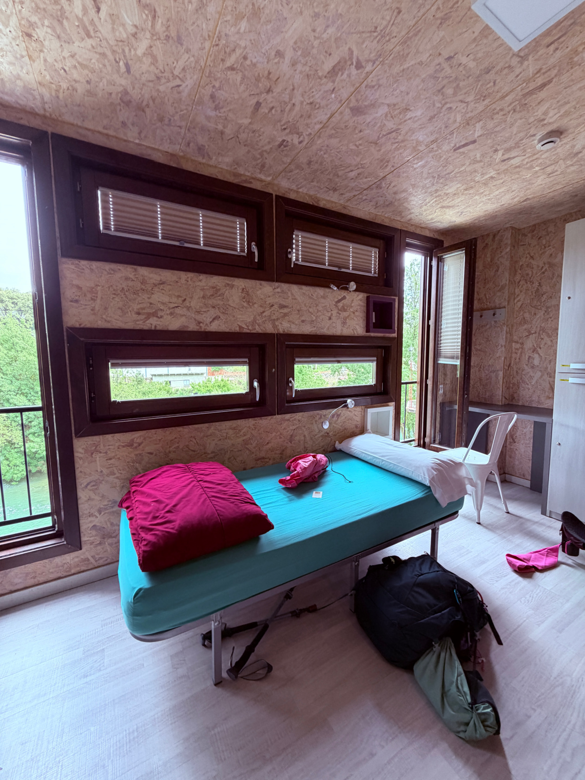 Private room at Hostería de Curtidores in Estella, Spain, with a single bed, river views, and modern amenities for Camino de Santiago pilgrims.