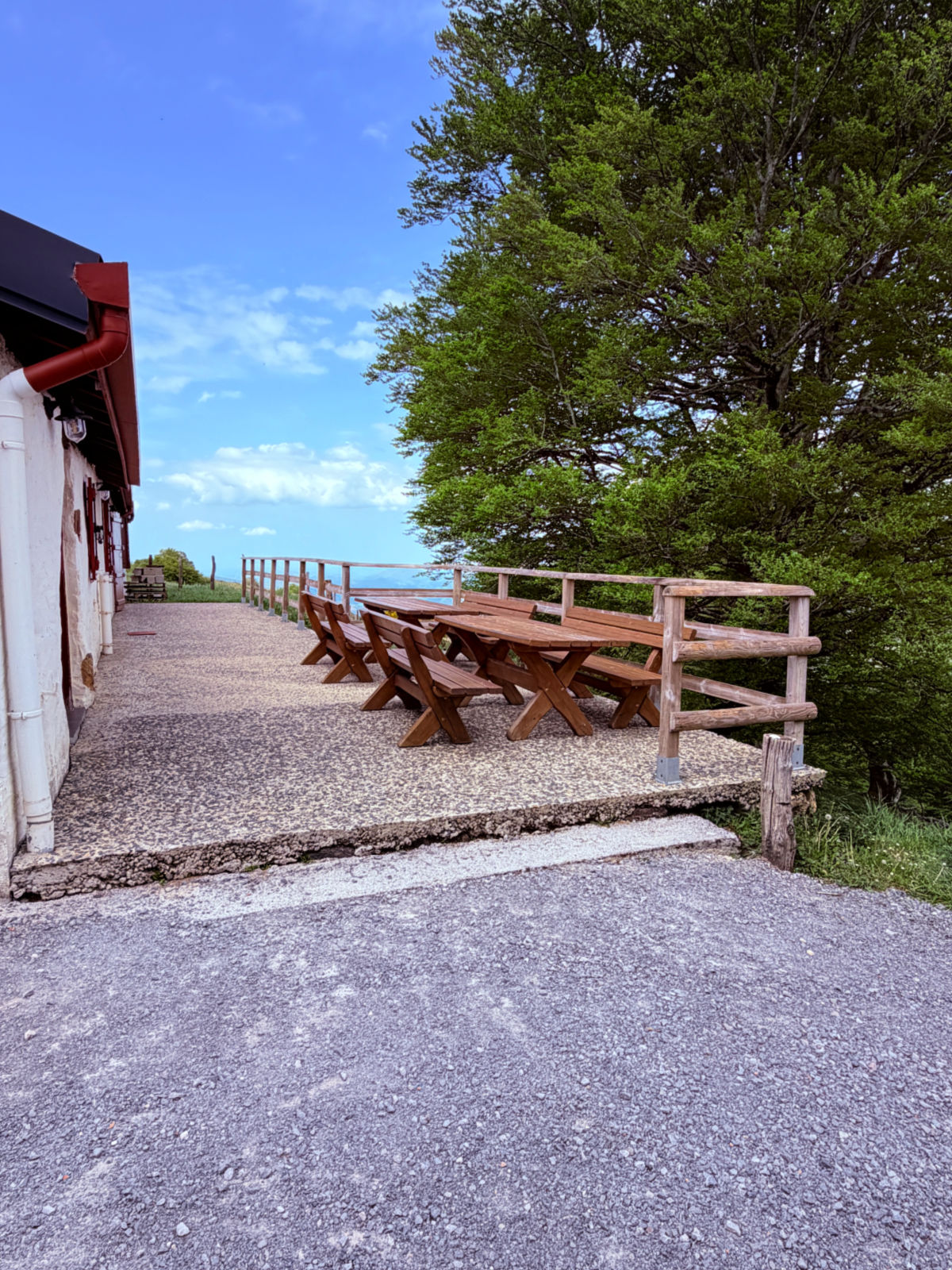 Outdoor picnic tables overlooking the countryside at Auberge Borda on the Camino de Santiago.