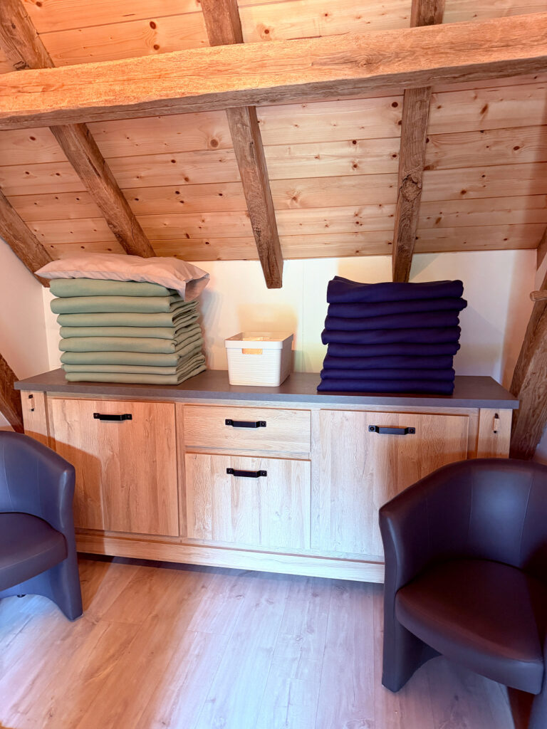 Stacks of folded blankets available for pilgrims inside Auberge Borda.