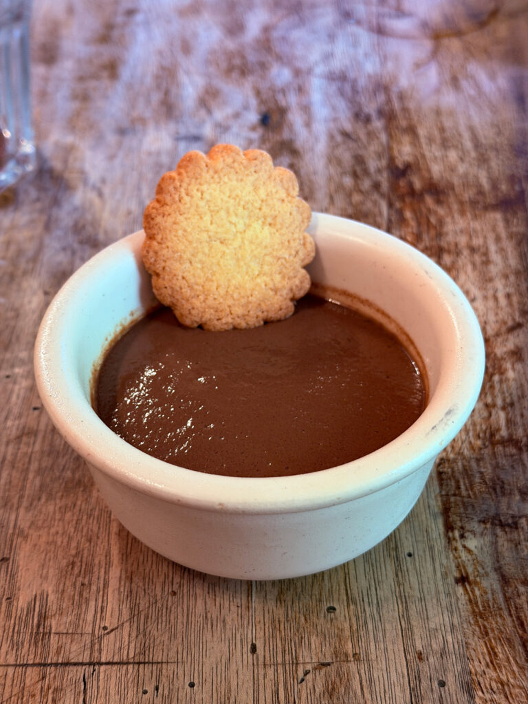 Rich chocolate pudding topped with a butter cookie served for dessert at Auberge Borda.