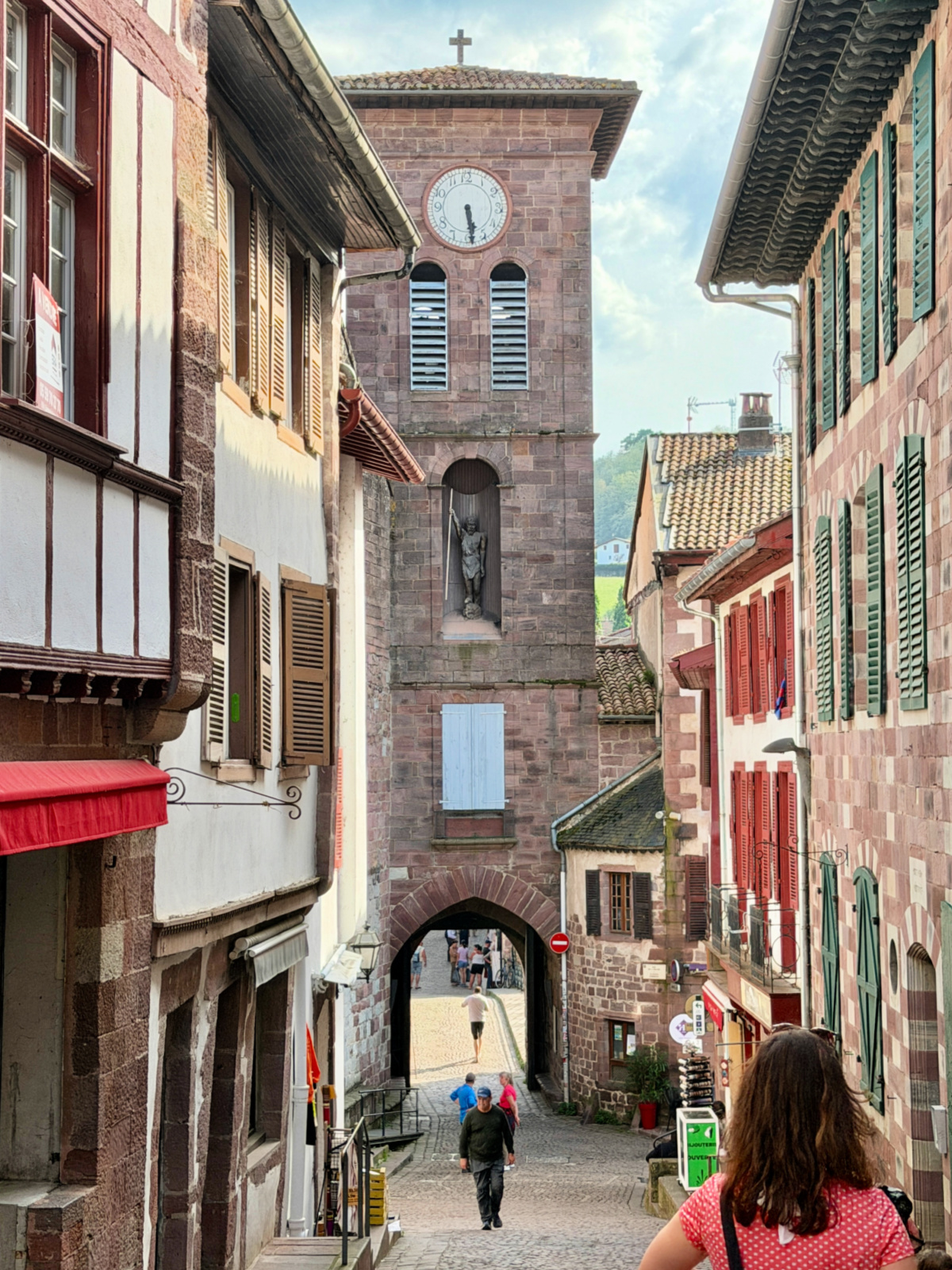 Historic stone gate and clock tower leading into the medieval old town of Saint-Jean-Pied-de-Port, France.