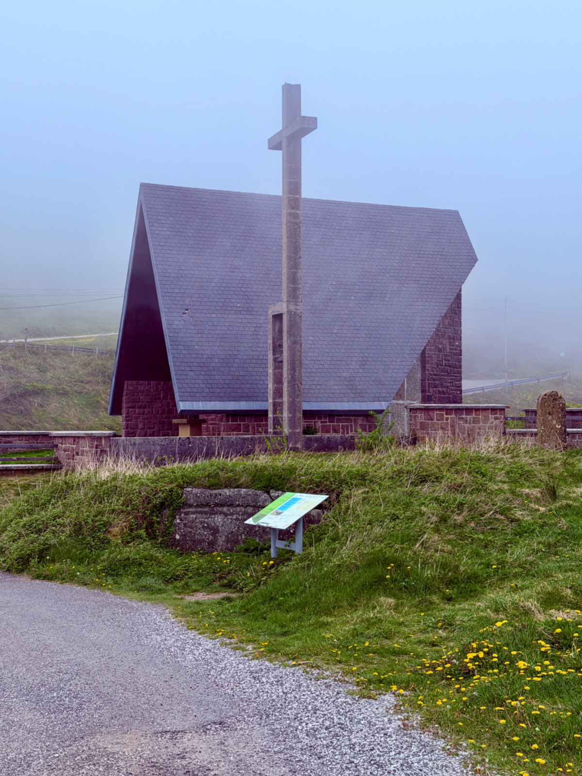 Small mountain chapel surrounded by fog along the Camino route through the Pyrenees.