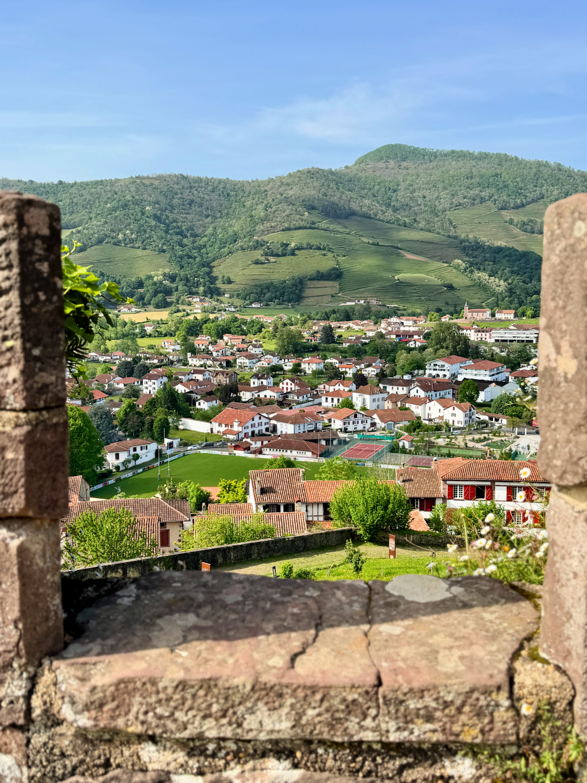 View over Saint-Jean-Pied-de-Port and the surrounding green hills from the town's historic citadel.