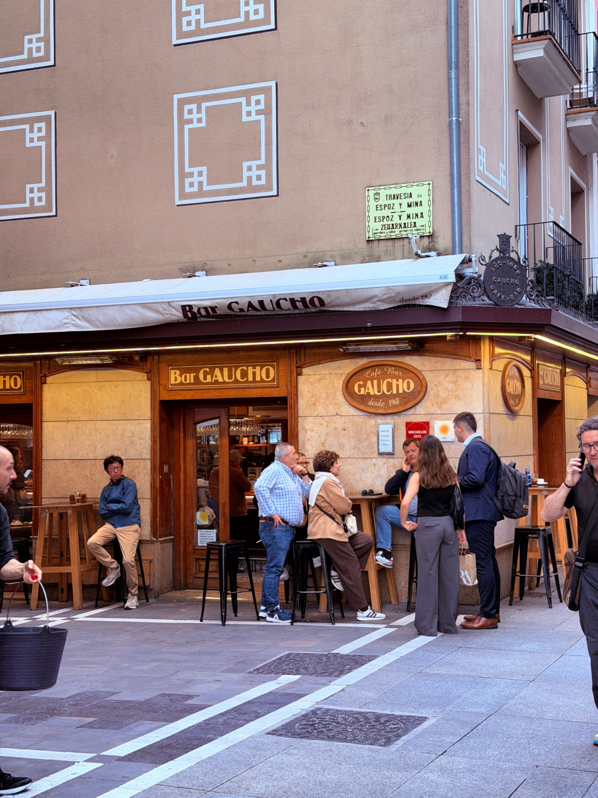 Patrons gather outside Bar Gaucho on a narrow street in Pamplona’s Old Town.