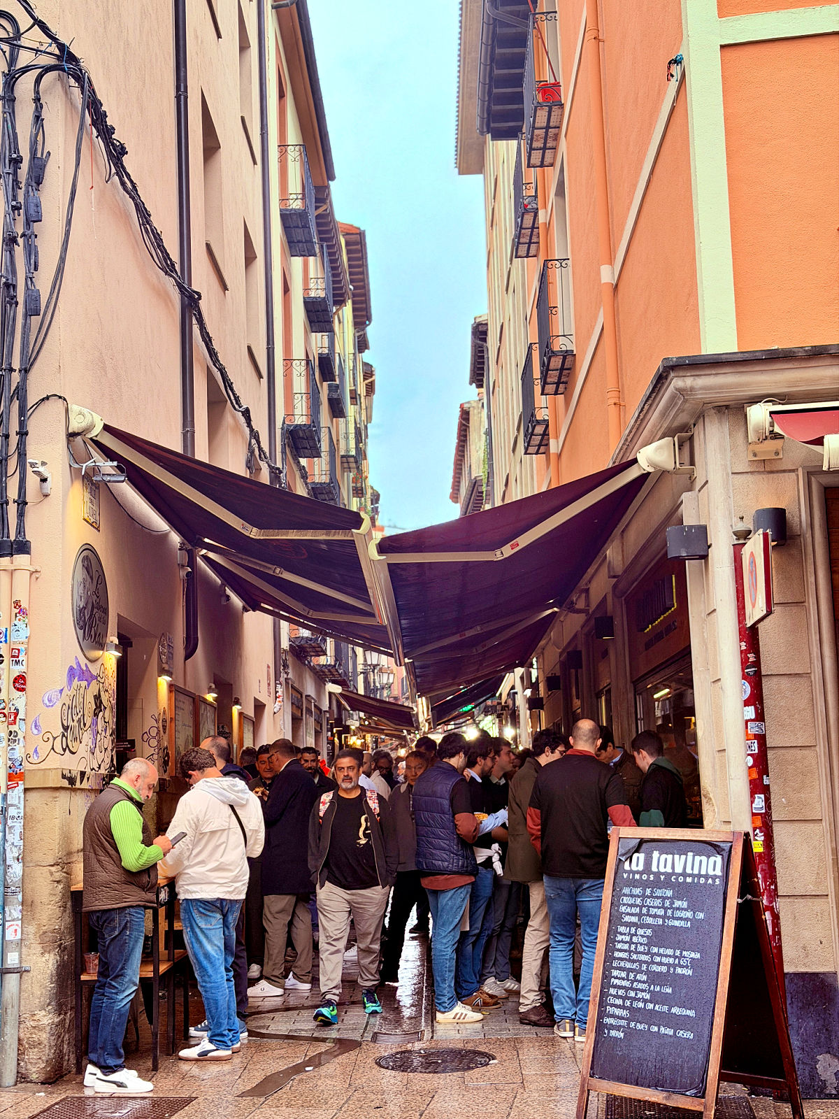 Crowds gathering outside tapas bars along Calle Laurel in Logroño, Spain.