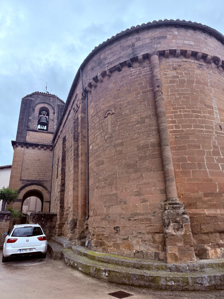 Rounded stone exterior of a historic church in Spain.