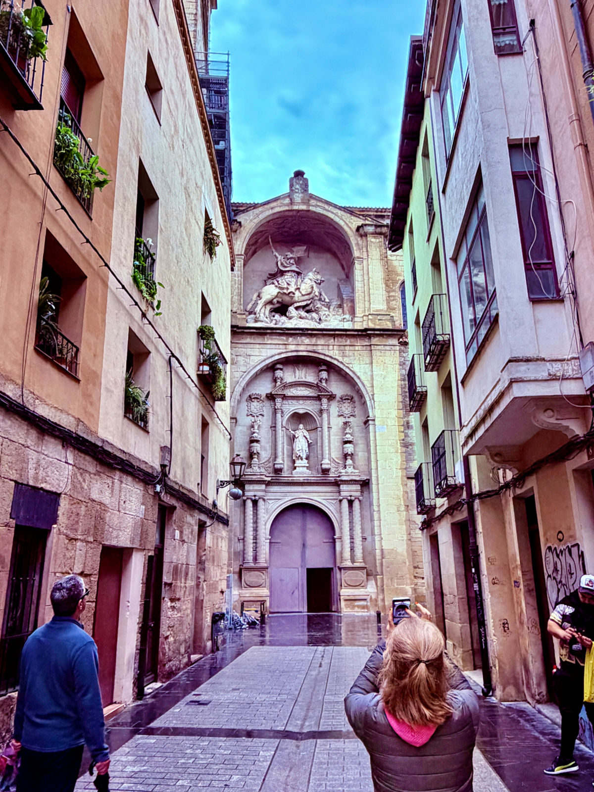 Ornate entrance of San Bartolomé Church at the end of a narrow street in Logroño.