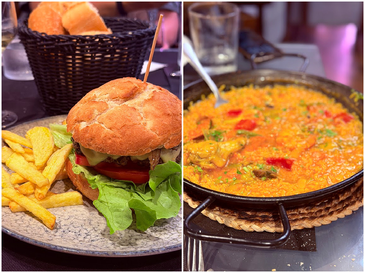 Burger with fries and a pan of Spanish rice served for dinner in Puente la Reina.