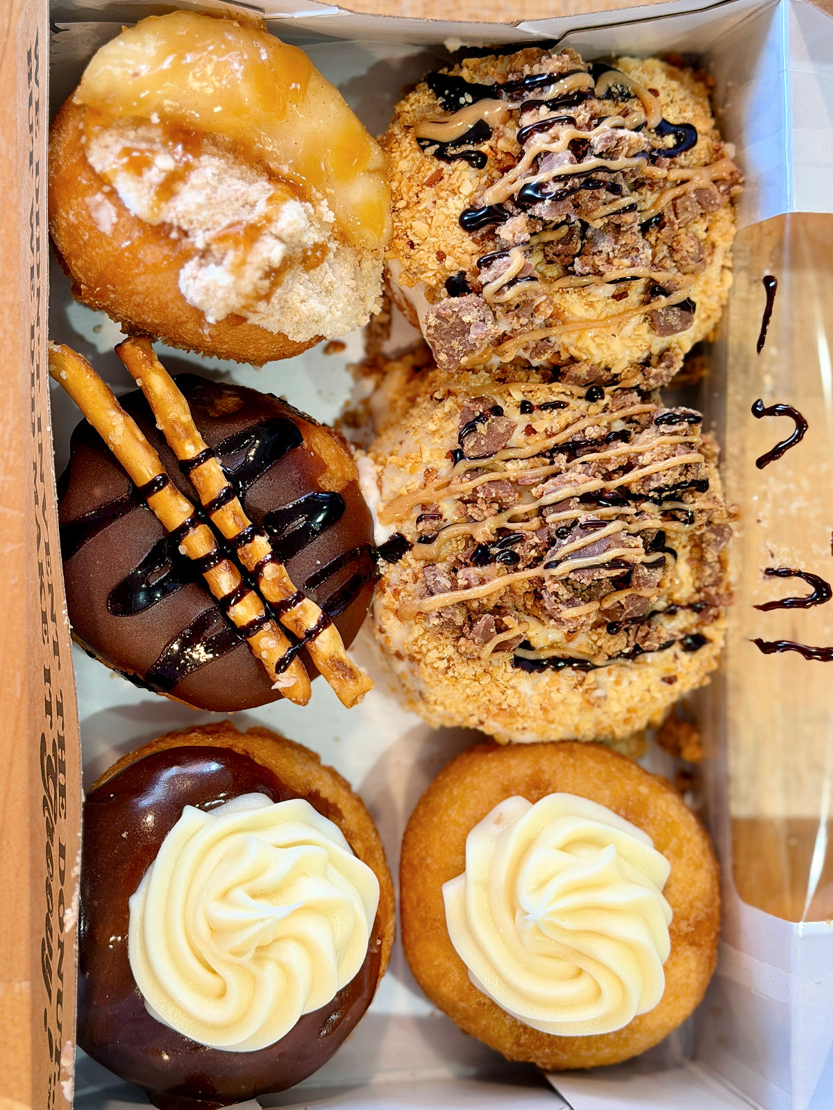 Box of colorful mini donuts from Peace, Love and Little Donuts in Pittsburgh's Strip District.