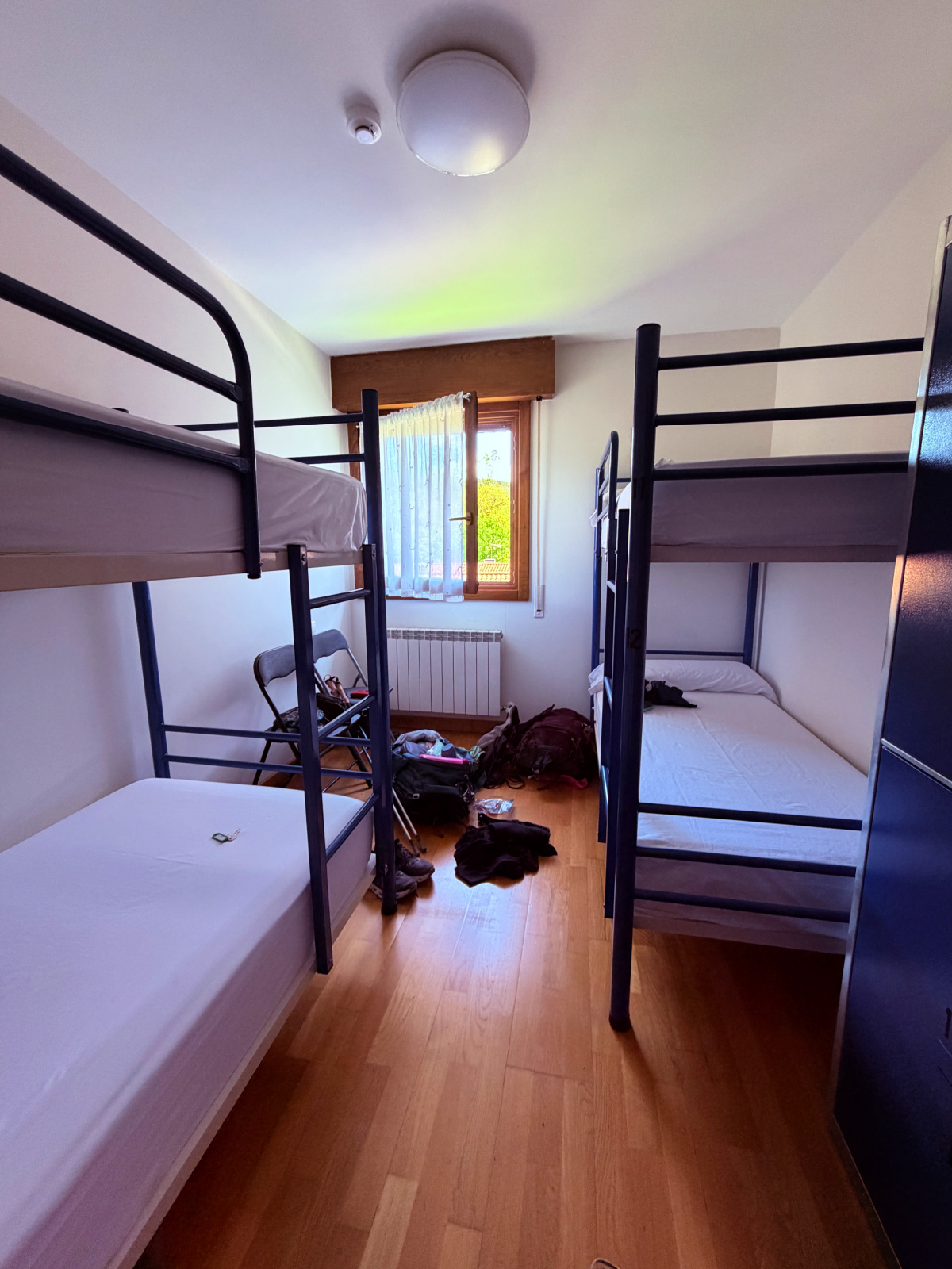 Rows of bunk beds inside a pilgrim hostel on the Camino de Santiago.