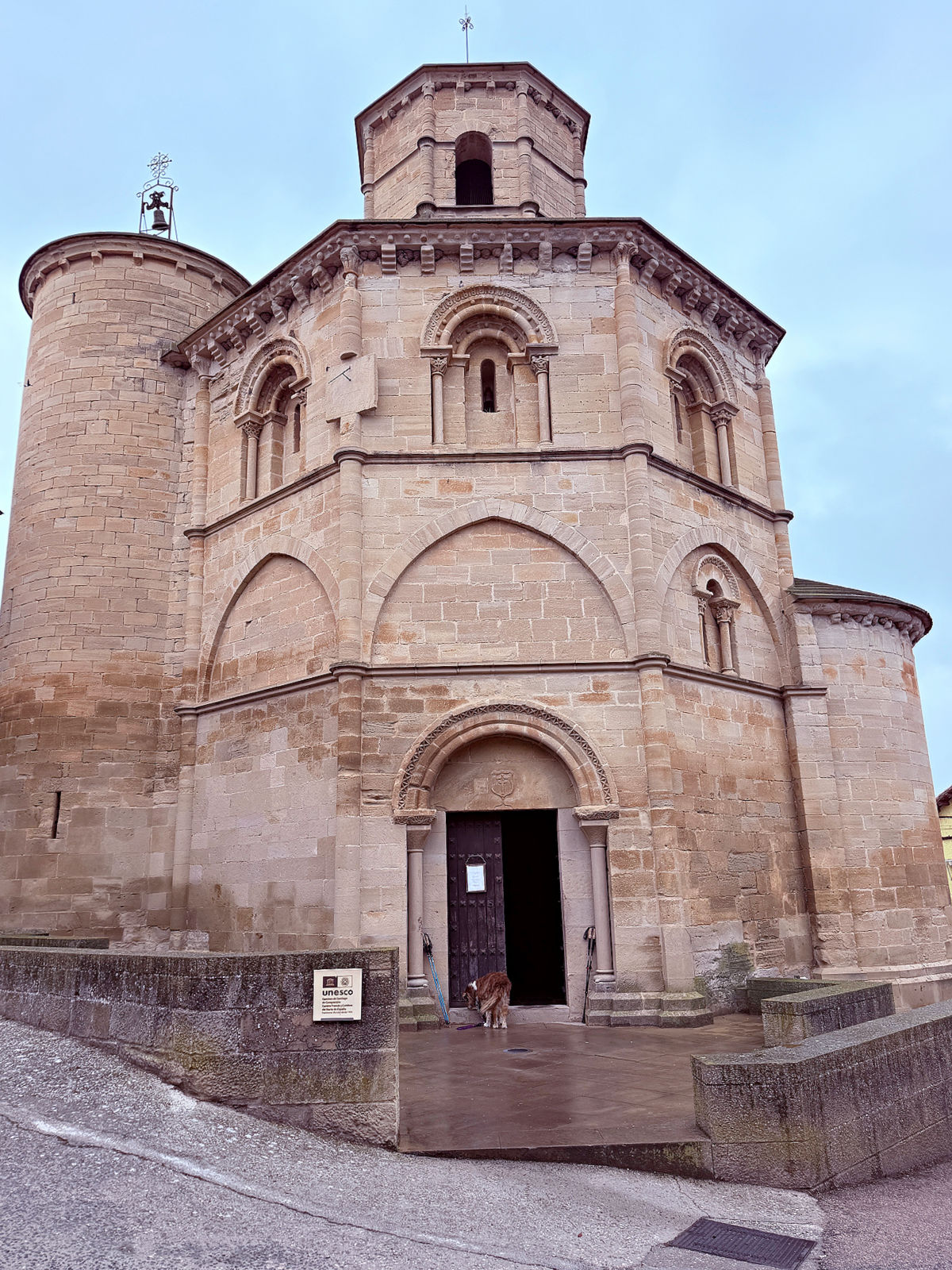 Romanesque stone exterior of Iglesia del Santo Sepulcro in Torres del Río, Spain.
