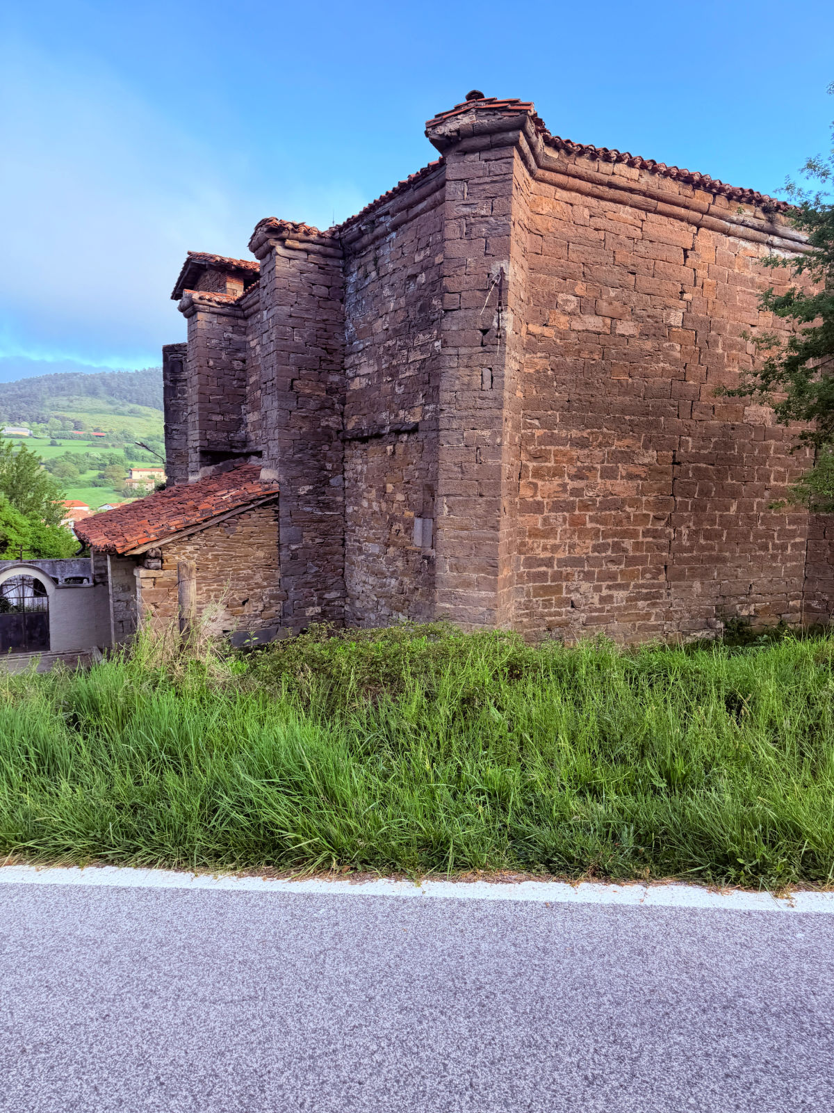 Weathered stone building with a tiled roof beside the Camino de Santiago in Navarra.