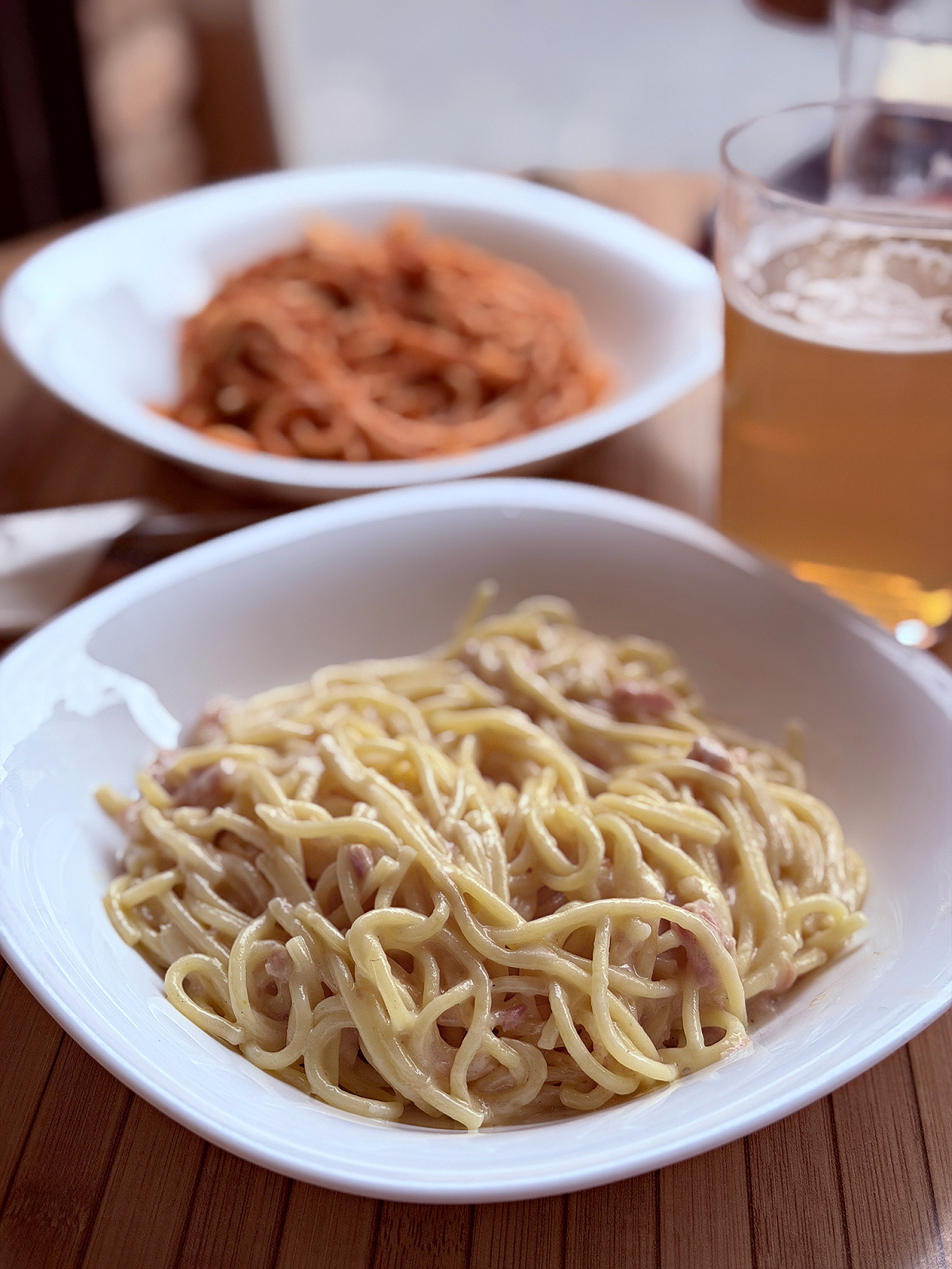 Plates of pasta served with a cold beer after a day of walking the Camino.