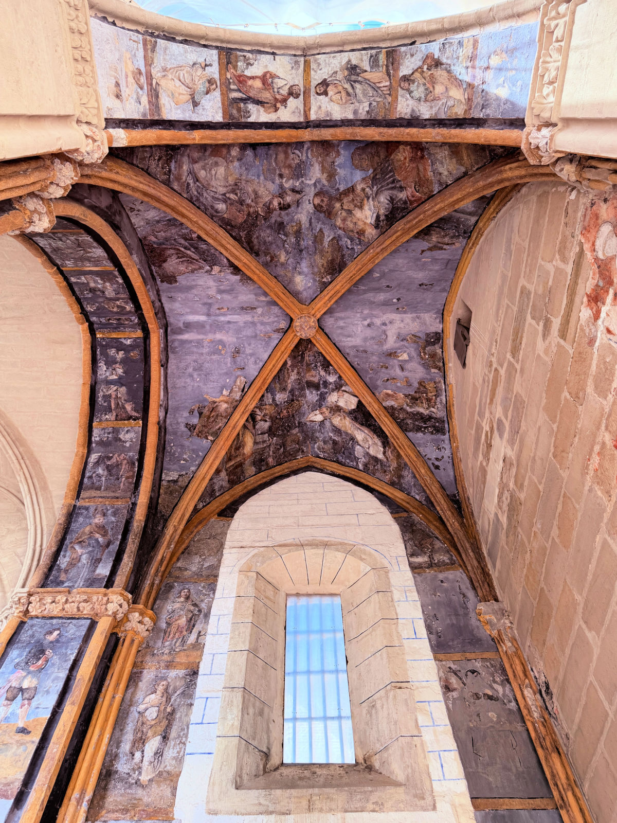 Stone vaulted ceiling and arched window inside the ruins of San Pedro Church in Viana.