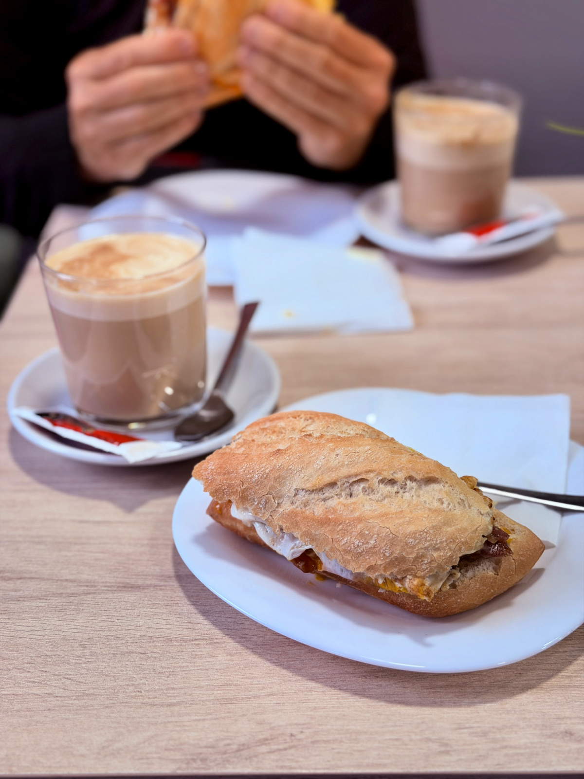 Spanish breakfast of coffee and a toasted sandwich served at a café.