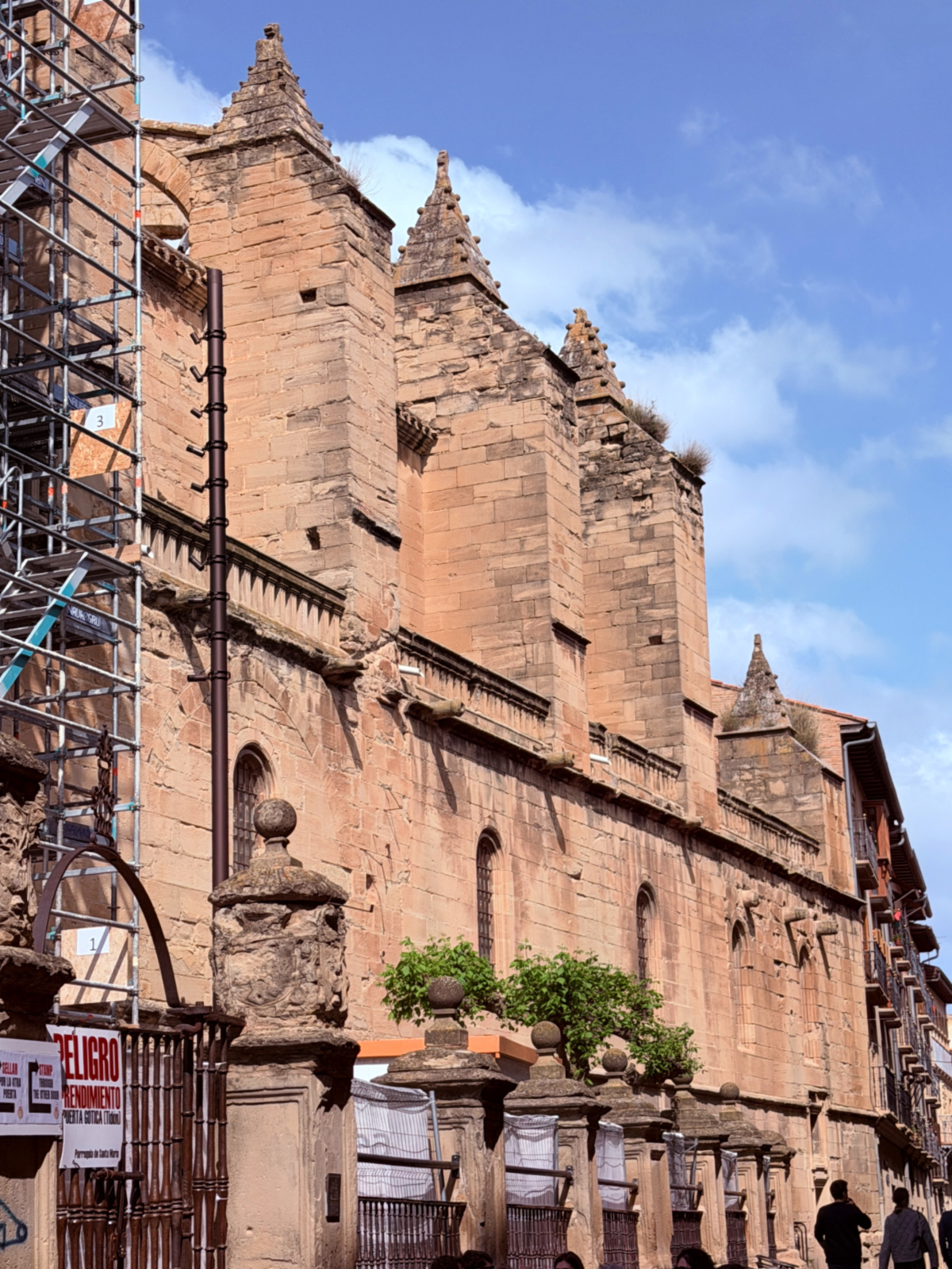 Historic stone church rising above a street in Viana, Spain.